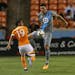 Houston Dynamo forward Mauro Manotas (19) and Minnesota United defender Michael Boxall (25) battle for possession of the ball during the first half of