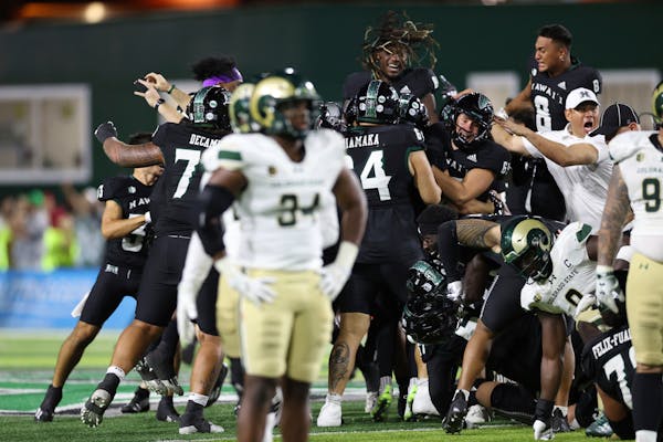 Hawaii rushes the field after place kicker Matthew Shipley (2) kicked a 51-yard field goal to defeat Colorado State 27-24 at the end of the second hal
