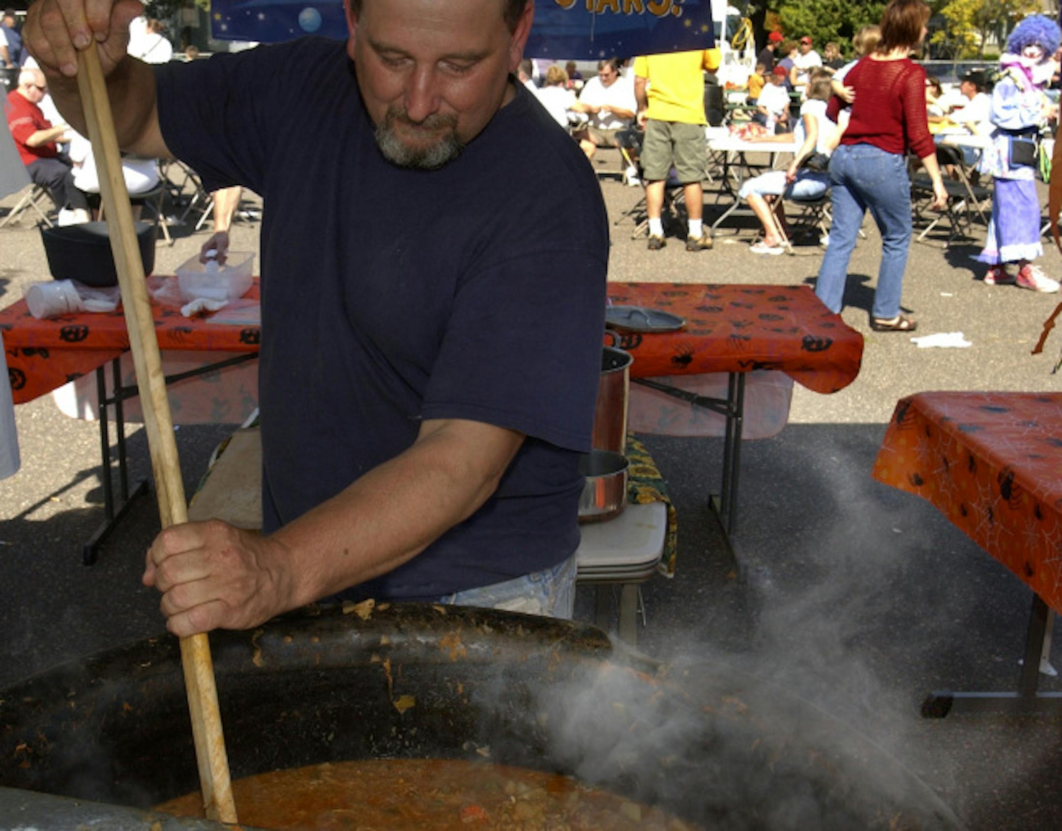Joey McLeister/Star Tribune South St. Paul,Mn.,Sat., Oct. 1, 2005--Bill Long of White Bear Lake stirs his booya made from his mother's old booya recipe including ingredients such as ox tails, rutabagas, chicken, peas, etc. Long has a long family history of booya making. GENERAL INFORMATION: The 18th Annual World Championship Booya Festival was held in South St. Paul.
