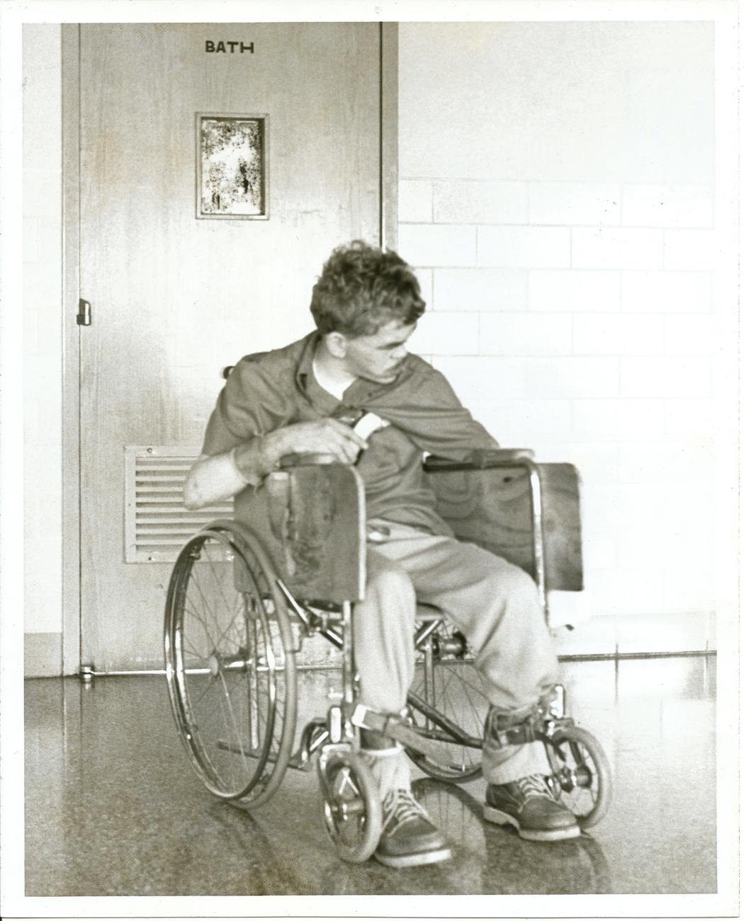 A boy in an institution, strapped to a wheelchair, spent most of his time in restraints.