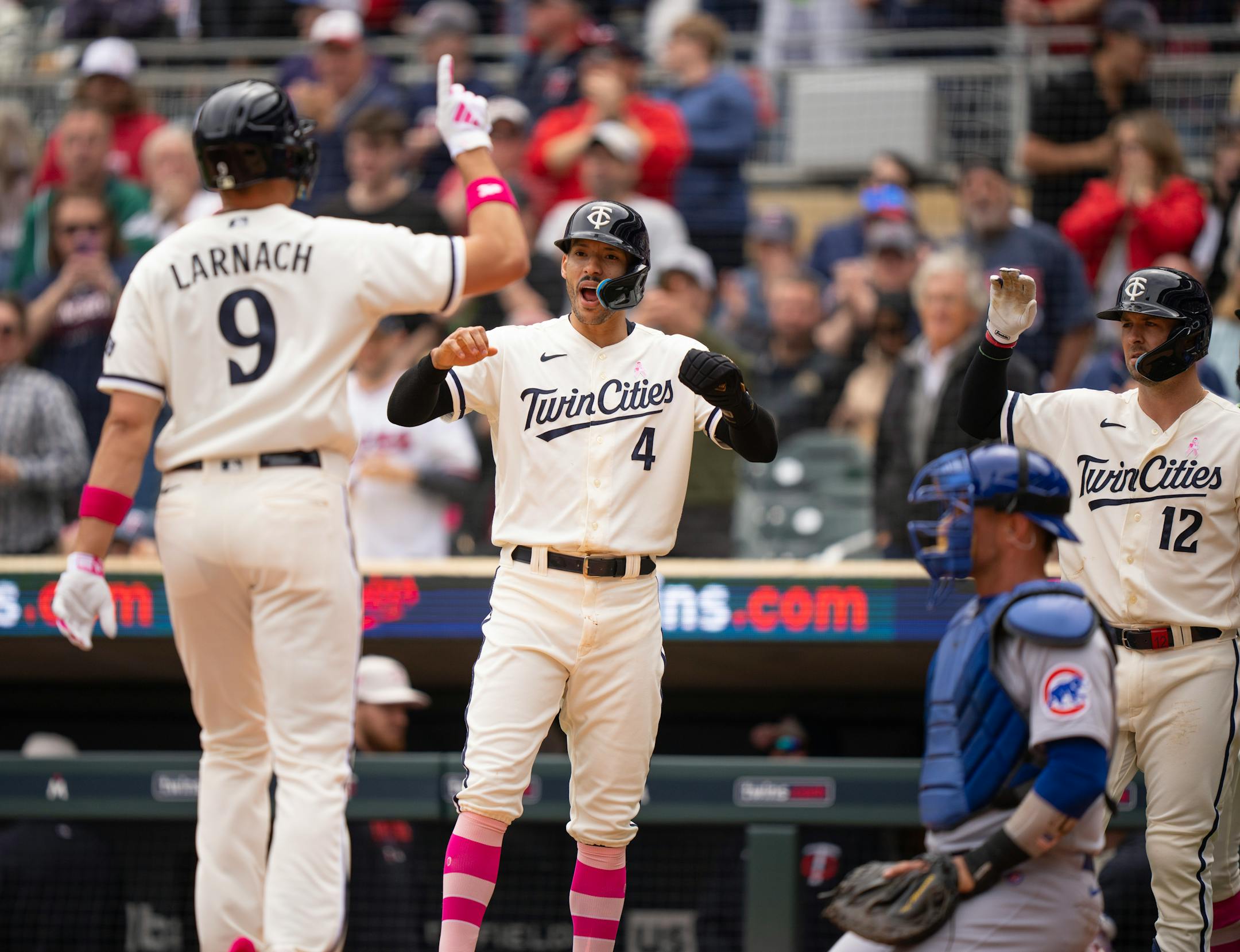 Minnesota Twins shortstop Carlos Correa (4) greeted Twins right fielder Trevor Larnach (9) after his three run homer in the third inning.