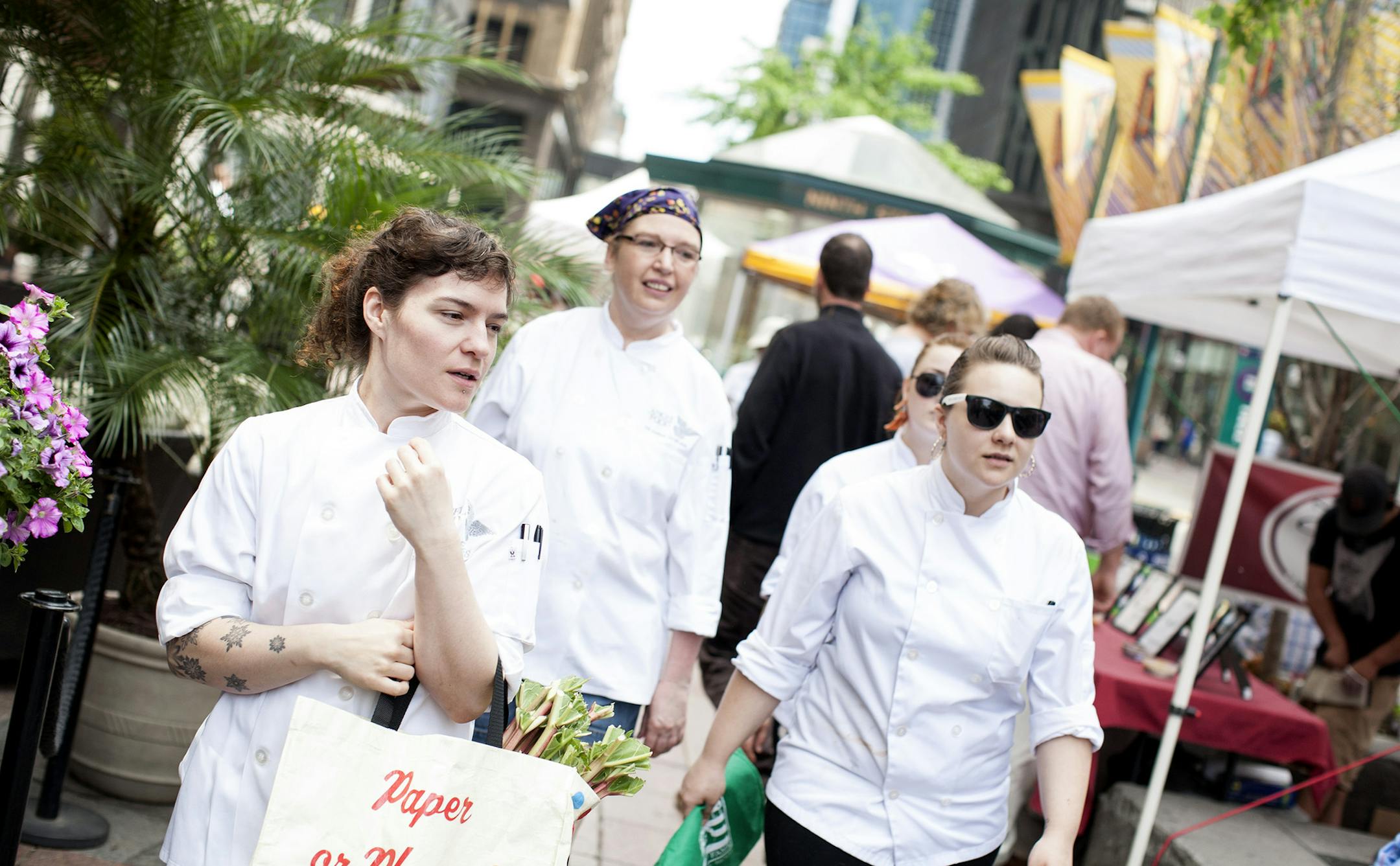 Left to right, Angel Food co-owner and pastry chef Katy Gerdes steps out to purchase some fresh, local produce with co-workers Deanna Doran, Tiffany Ashmead, and Crystal Schmidt at the Minneapolis Farmers Market on Nicollet Mall June 5, 2014. (Courtney Perry/Special to the Star Tribune)
