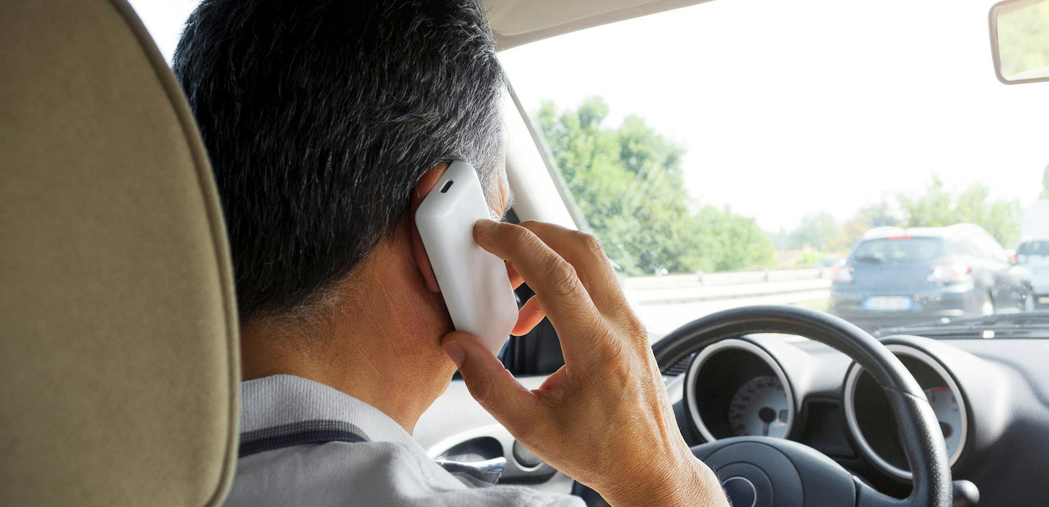 iStockphoto.com
Man on the phone driving a car on highway.