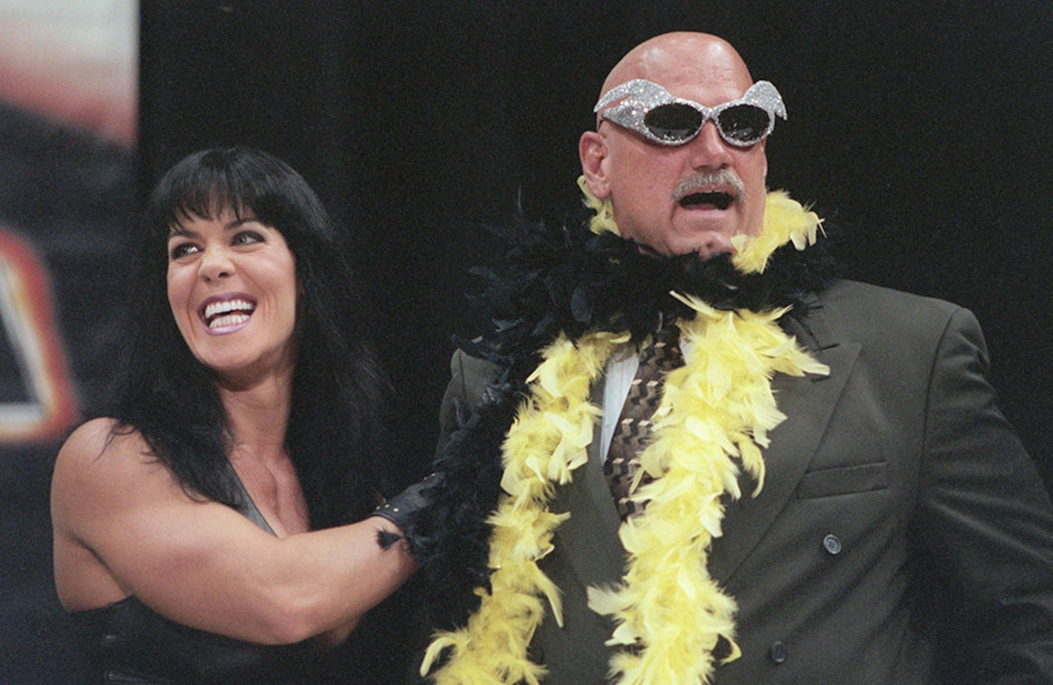 A news conference is held to discuss Gov. Jesse Ventura's involvement in the World Wrestling Federation's ``SummerSlam'' event on August 22. WWF Chairman Vince McMahon, ---July 14, 1999-- -- Chyna places a feather boa on Minnesota Governor Jesse Ventura, during a press conference at the Target Center in Minneapolis on Wednesday morning. It was announced the Jesse ÏThe BodyÓ Ventura will referee the Championship match at SummerSlam Ì99 which will be held at The Target Center August 22.