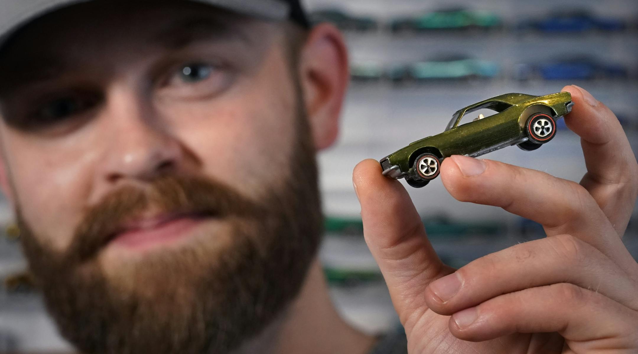Avid Hot Wheels collector Ryan Wurzbacher held up his favorite car, a 1968 olive green Camaro with a white interior that cost him about $2,000.