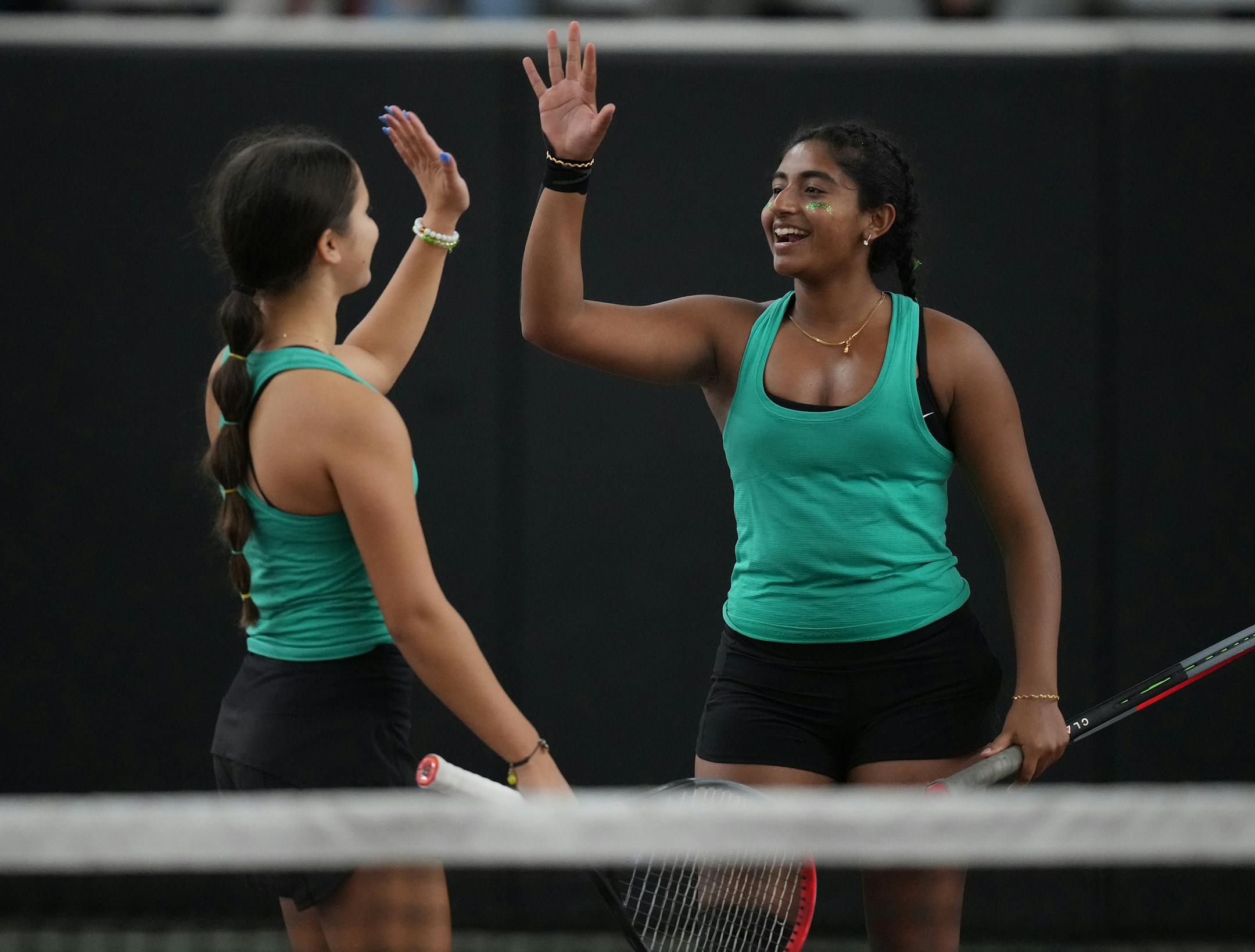 Keely Ryder and Nandini Iyer of Mayo celebrate a play at  the Baseline Tennis Center in Minneapolis, Minnesota on Wednesday, Oct. 25, 2023.