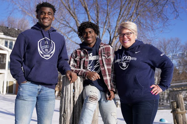 Dawn Gillman, who's become the face of the Let Them Play MN, stood for a portrait with her sons Eli, 17, left, and Monte, 15, both three-sport athlete