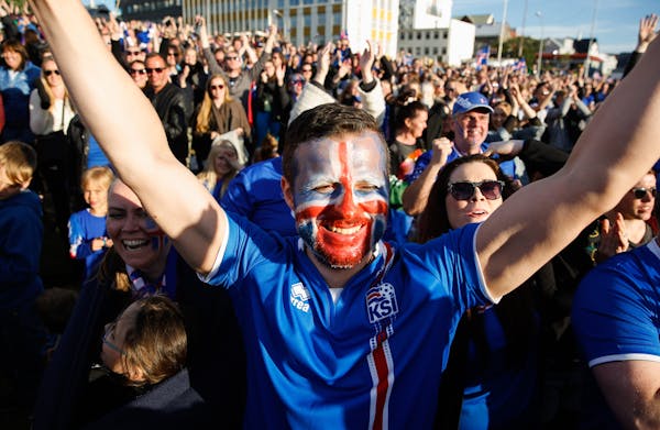Iceland soccer fans watch the Euro 2016 quarterfinal match between Iceland and France on a large screen in Reykjavik, Iceland, Sunday July 3, 2016. (A