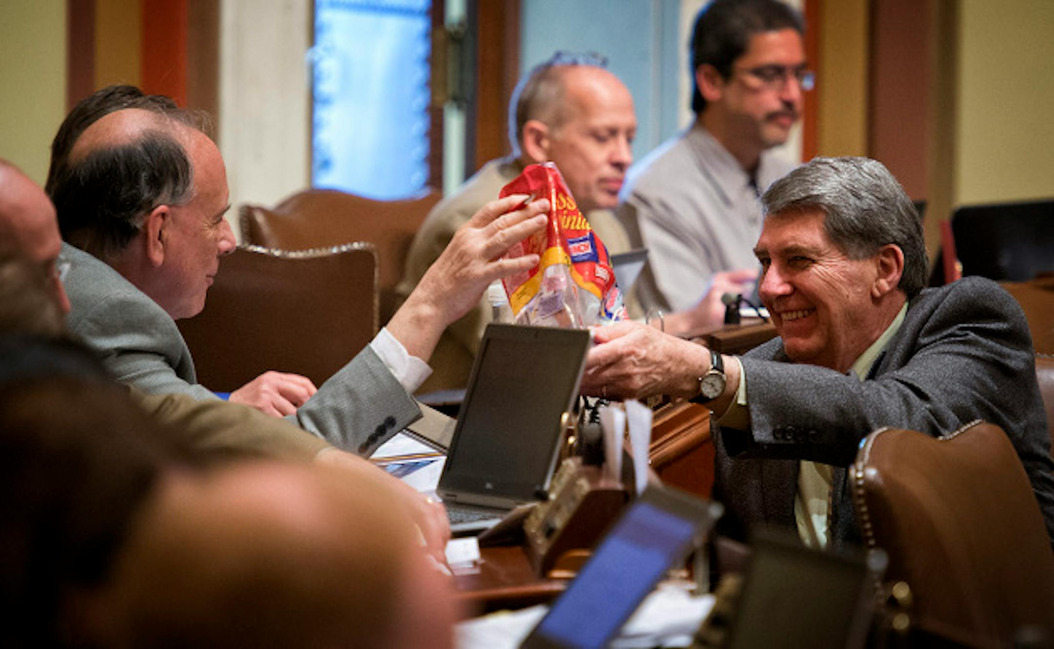 Rep. Jerry Newton, DFL-Coon Rapids, right passed a bag of tiny candy bars to Rep. Joe Mullery, DFL-Minneapolis during House debate of the tax bill.  Wednesday, April 24, 2013    ]       GLEN STUBBE * gstubbe@startribune.com