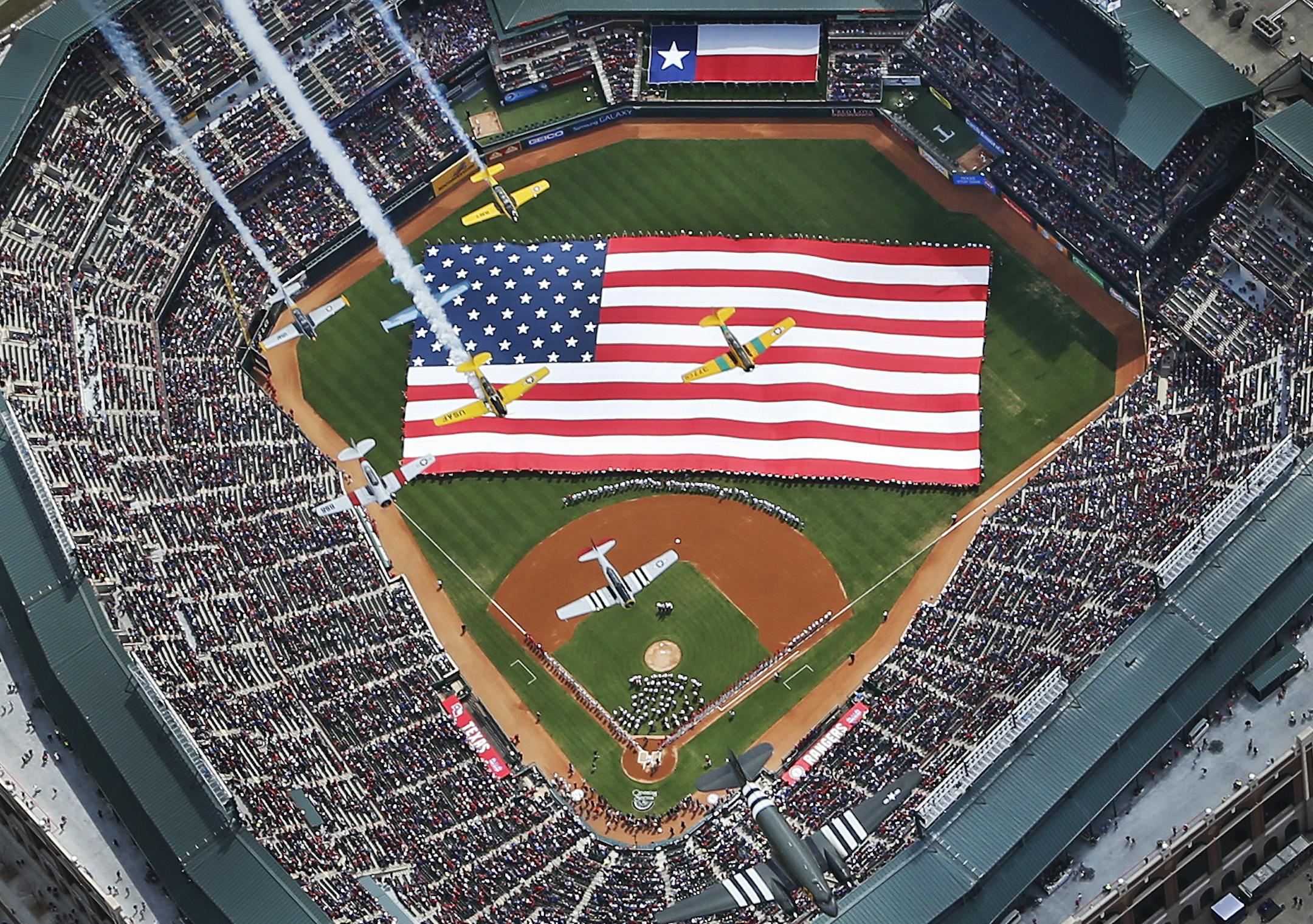 Vintage planes from the Cavanaugh Flight Museum flyover Globe Life Park during opening day ceremonies before a baseball game between the Texas Rangers and Philadelphia Phillies in Arlington, Texas, Monday, March 31, 2014. (AP Photo/The Dallas Morning News, Louis DeALuca ) MANDATORY CREDIT; MAGS OUT; TV OUT; INTERNET USE BY AP MEMBERS ONLY; NO SALES