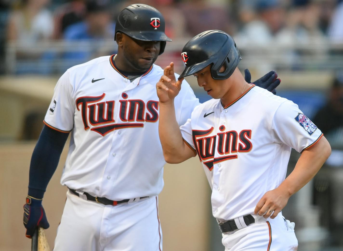 Minnesota Twins first baseman Miguel Sano (22) celebrated with left fielder Rob Refsnyder (38) after he scored a run off a wild pitch in the bottom of the second inning.