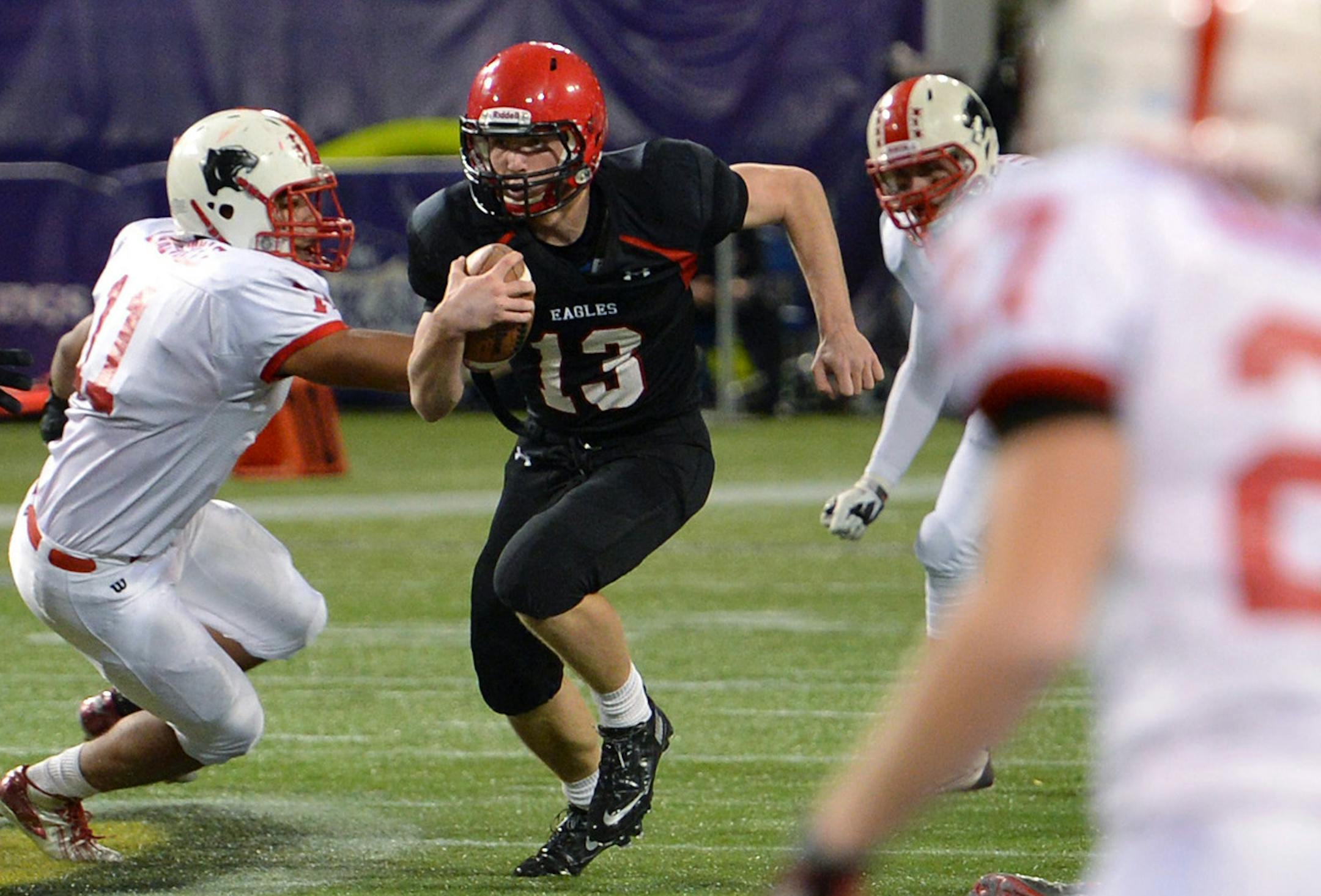 Eden Prairie's Ryan Connelly runs the ball through Lakeville North's defense during the first half of a Class 6A state football quarterfinal game Friday night at the Metrodome. ] (SPECIAL TO THE STAR TRIBUNE/BRE McGEE) **Ryan Connelly (black, 13)