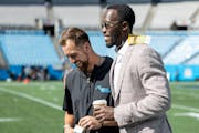 Former Vikings receiver Adam Thielen chats with General Manager Kwesi Adofo-Mensah before the Vikings played Thielen's new team, the Panthers, in Octo