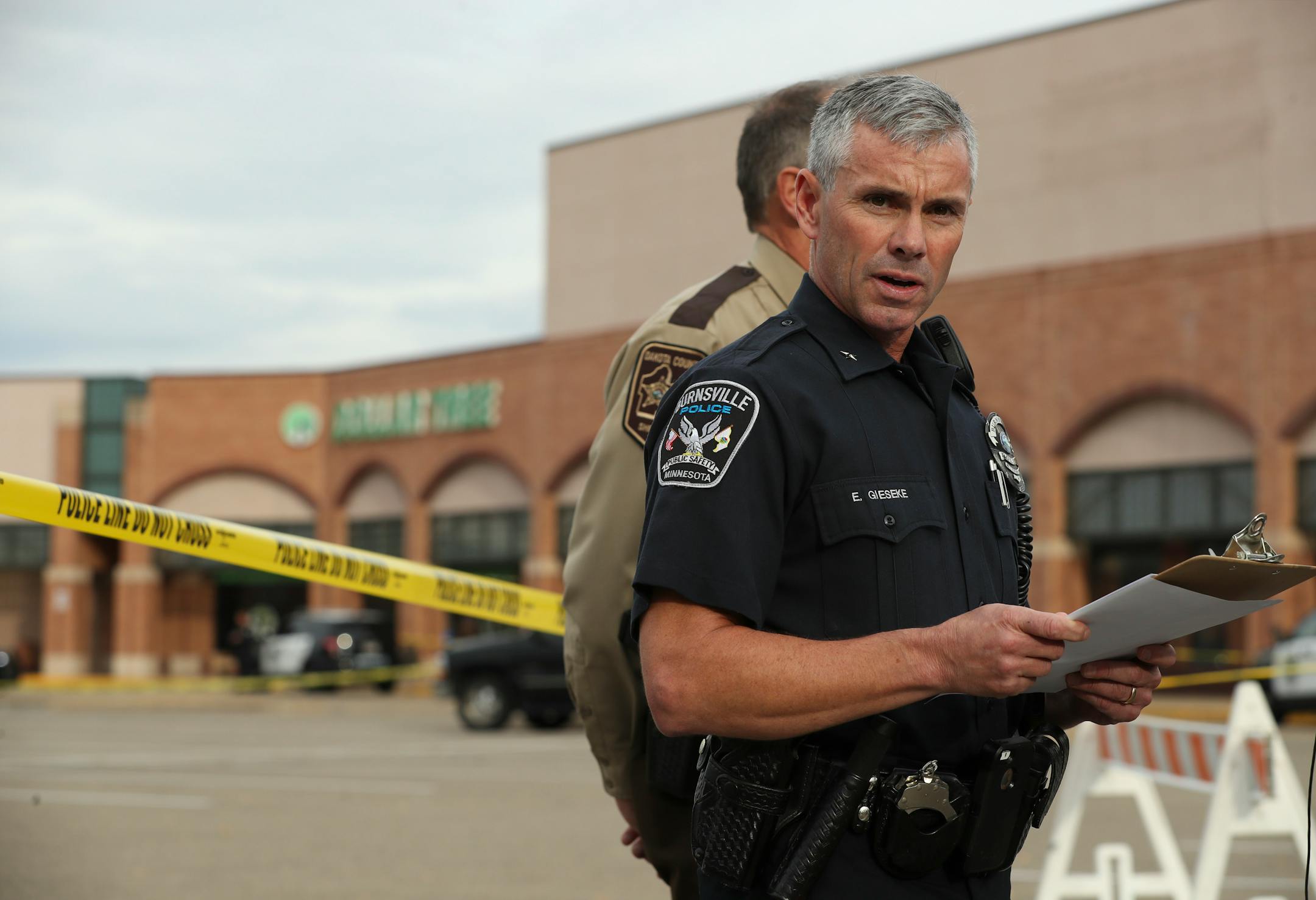 In this file photo, Burnsville Chief of Police Eric Gieseke briefed reporters Monday afternoon about the shooting of two people inside a Dollar Tree in the Burnsville shopping center behind him over the noon hour Monday.