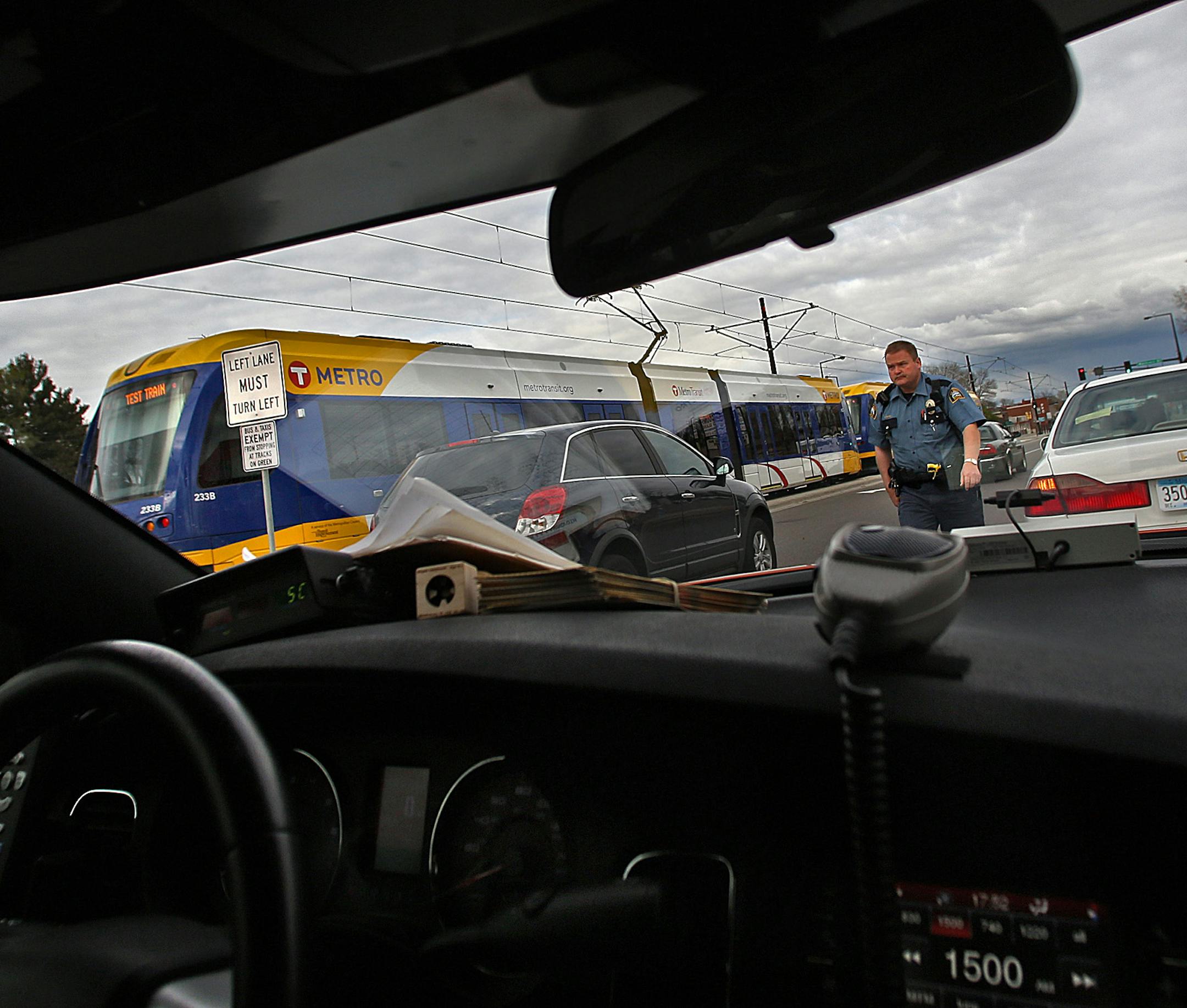 St. Paul Police officer Scott Braski patrolled an area in and around University Avenue, where the new Green Line light rail travels through St. Paul. Part of Braski‚Äôs duties included distributing informational materials that encourage safety to pedestrians and motorists around the Green Line, which opens to the public in June. ] JIM GEHRZ ‚Ä¢ jgehrz@startribune.com / Minneapolis, MN / May 15 , 2014 / 4:00 PM