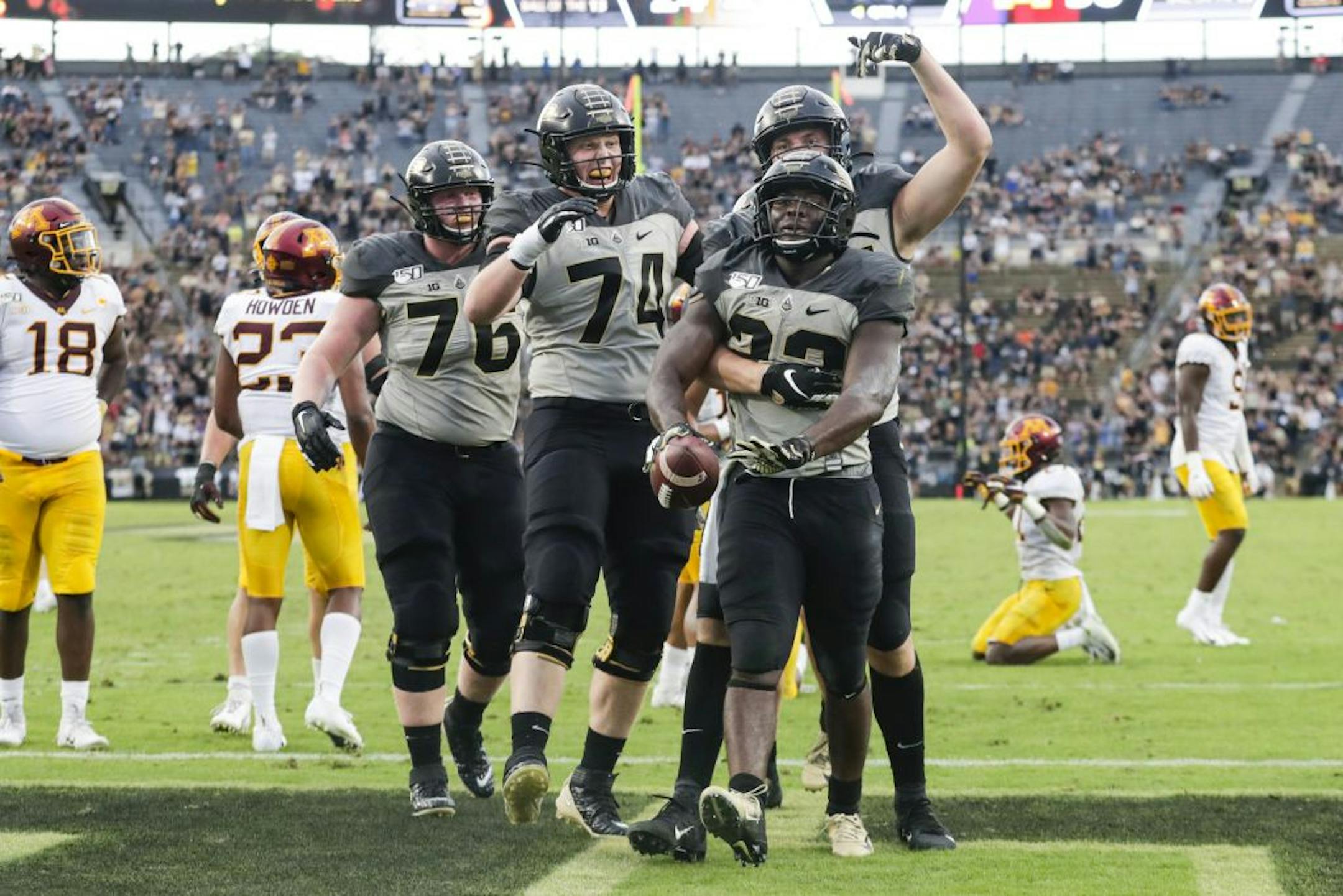 Purdue running back King Doerue (22) celebrates a touchdown against Minnesota with offensive lineman Eric Miller (74) and tight end Payne Durham (87) during the second half of an NCAA college football game in West Lafayette, Ind., Saturday, Sept. 28, 2019. Minnesota defeated Purdue 38-31.