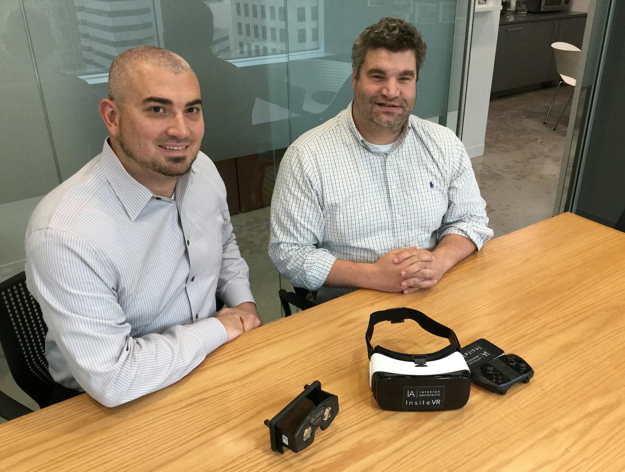 Doug Gigi, left, and Lance Wolfson, right, of Interior Architects' Charlotte office, displaying two virtual reality headsets. They're using virtual reality to show clients what buildings will be like inside before construction even starts, and to make changes on the fly quickly and easily. (Ely Portillo/Charlotte Observer/TNS) ORG XMIT: 1191496 ORG XMIT: MIN1610130002190703