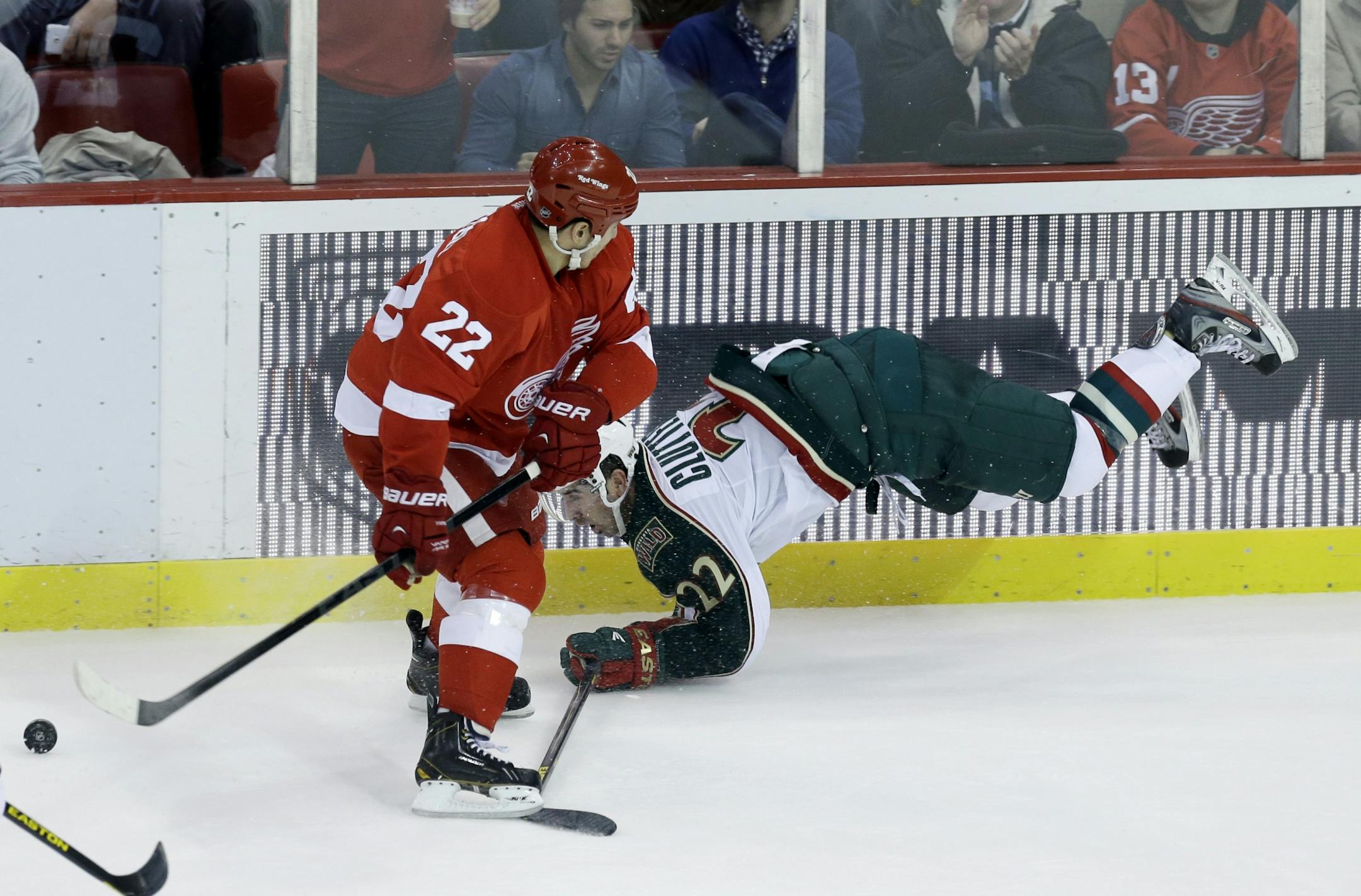 Red Wings right wing Jordin Tootoo checks Wild right wing Cal Clutterbuck