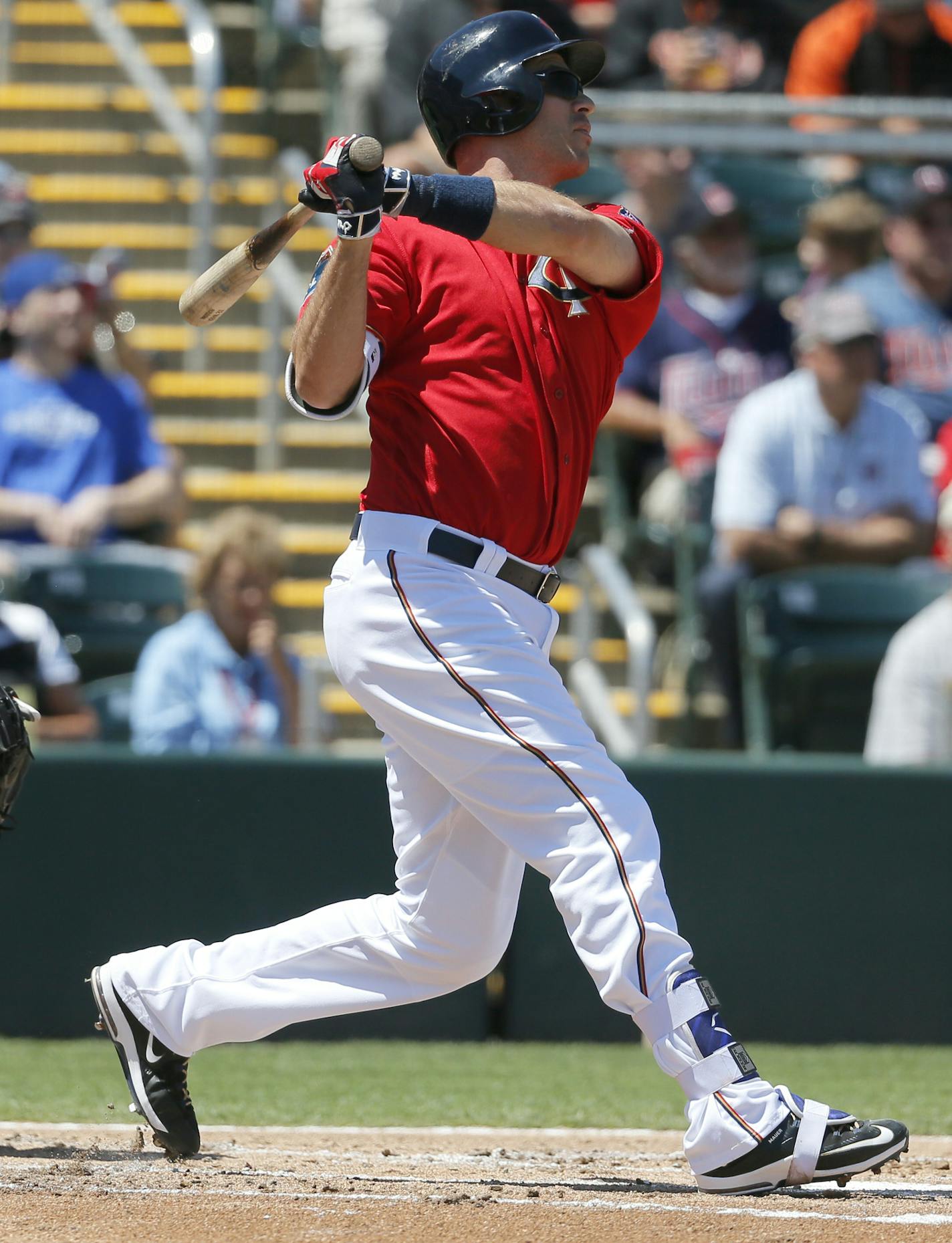 Minnesota Twins' Joe Mauer follows through on a two-run home run swing against a pitch from Baltimore Orioles' Mike Wright in the first inning of a spring training baseball game, Tuesday, March 22, 2016, in Fort Myers, Fla. (AP Photo/Tony Gutierrez)