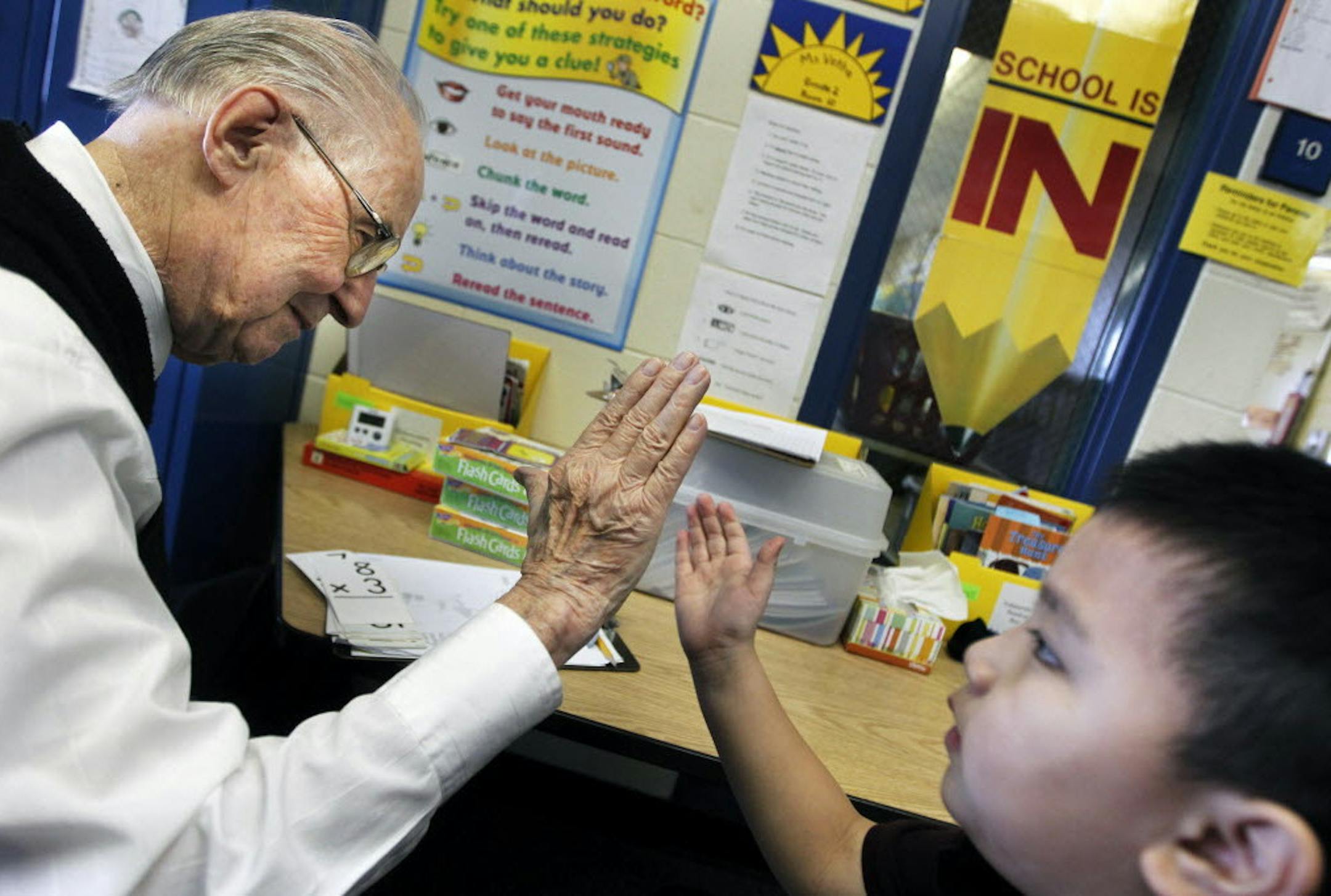 File photo from March 23, 2011 of Andy Anderson, a retired salesman and avid school volunteer, helping Lawthoua Xiong with math at Sunset Hill Elementary in Plymouth. He's been on a crusade to make people more appreciative of teachers.