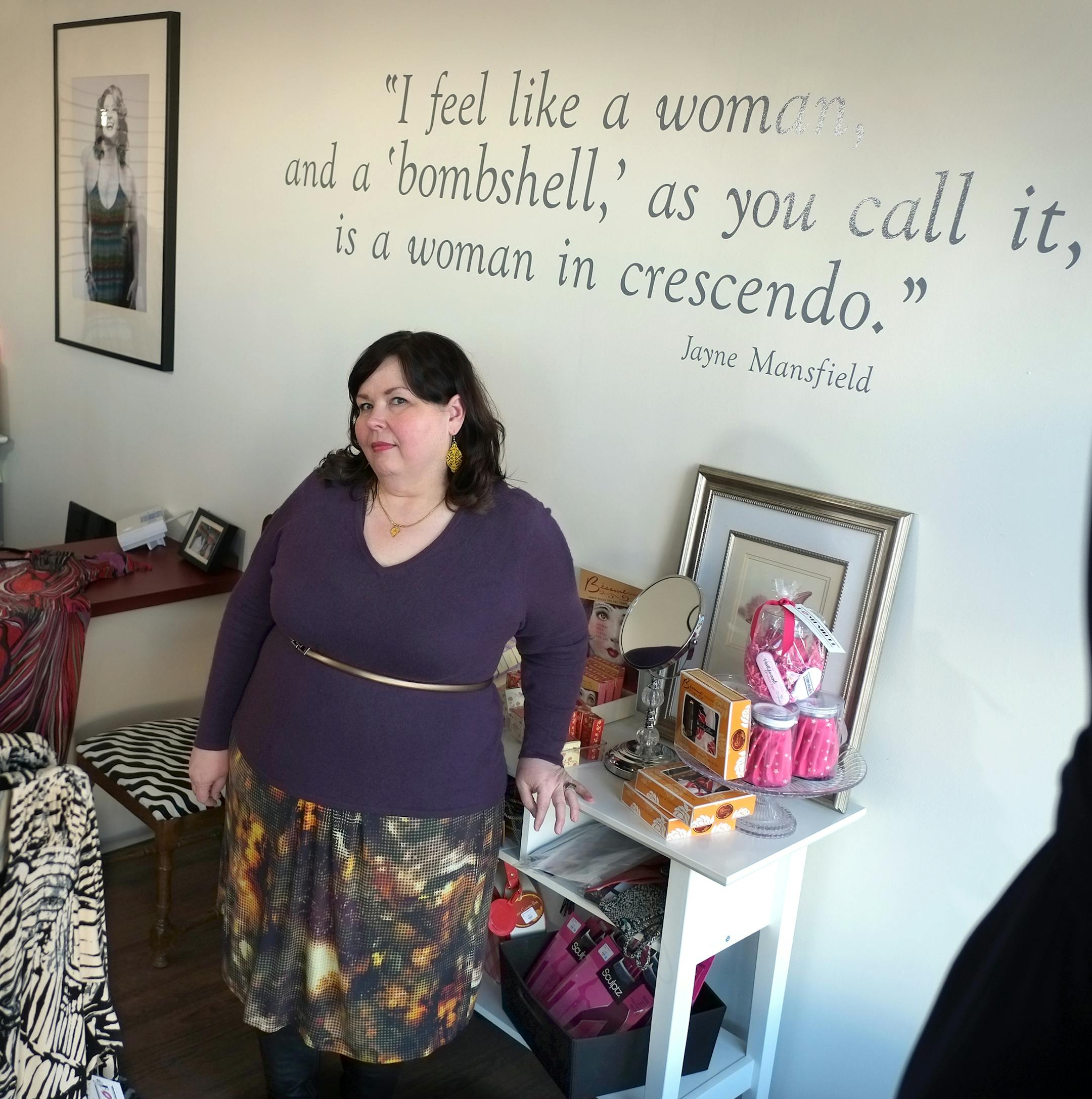 Denise Alden, owner of Bombshell, a plus-size boutique in St. Paul, and her customers, modeled flattering plus-size fashions. ] TOM WALLACE • twallace@startribune.com _ Assignments #20027679A_ February 19, 2013_ SLUG: 90980 PLUSSIZE030213 _ EXTRA INFORMATION: Photos were taken on location at the Bombshell store. Gennae Falconer is wearing the Cherry Velvet, "daphne" dress by photo and the Kiyonna, "Whimsy" dress under the painted quote. Wendy Hull Igigi "Skye" dress in front of couch. Den