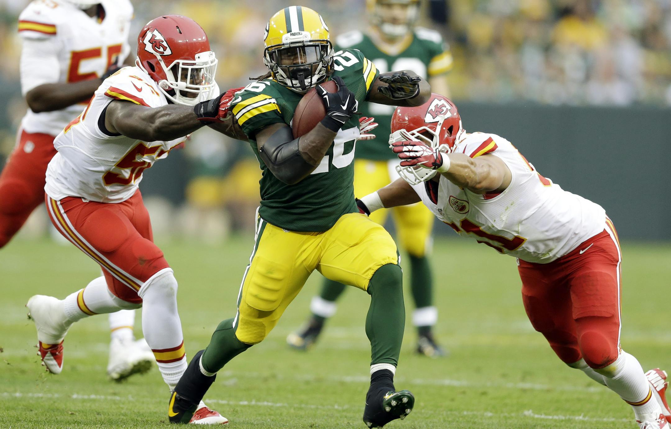 Green Bay Packers' DuJuan Harris tries to get away from Kansas City Chiefs' Frank Zombo (51) and James-Michael Johnson during the first half of an NFL football preseason game Thursday, Aug. 28, 2014, in Green Bay, Wis. (AP Photo/Tom Lynn) ORG XMIT: WIMG111