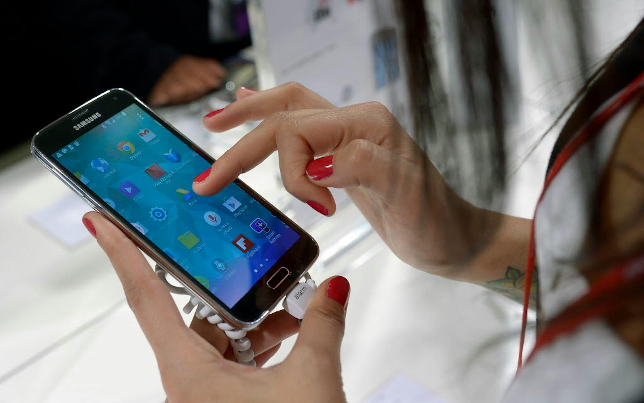 FILE - In this Feb. 25, 2014, file photo, a Samsung Galaxy S5 is demonstrated at the Mobile World Congress, the world's largest mobile phone trade show in Barcelona, Spain. Federal regulators have approved new broadband privacy rules that make internet service providers like Comcast and Verizon ask customers� permission before using or sharing much of their data. The Federal Communications Commission�s measure was scaled back from a previous proposal but was still criticized by the advertising,