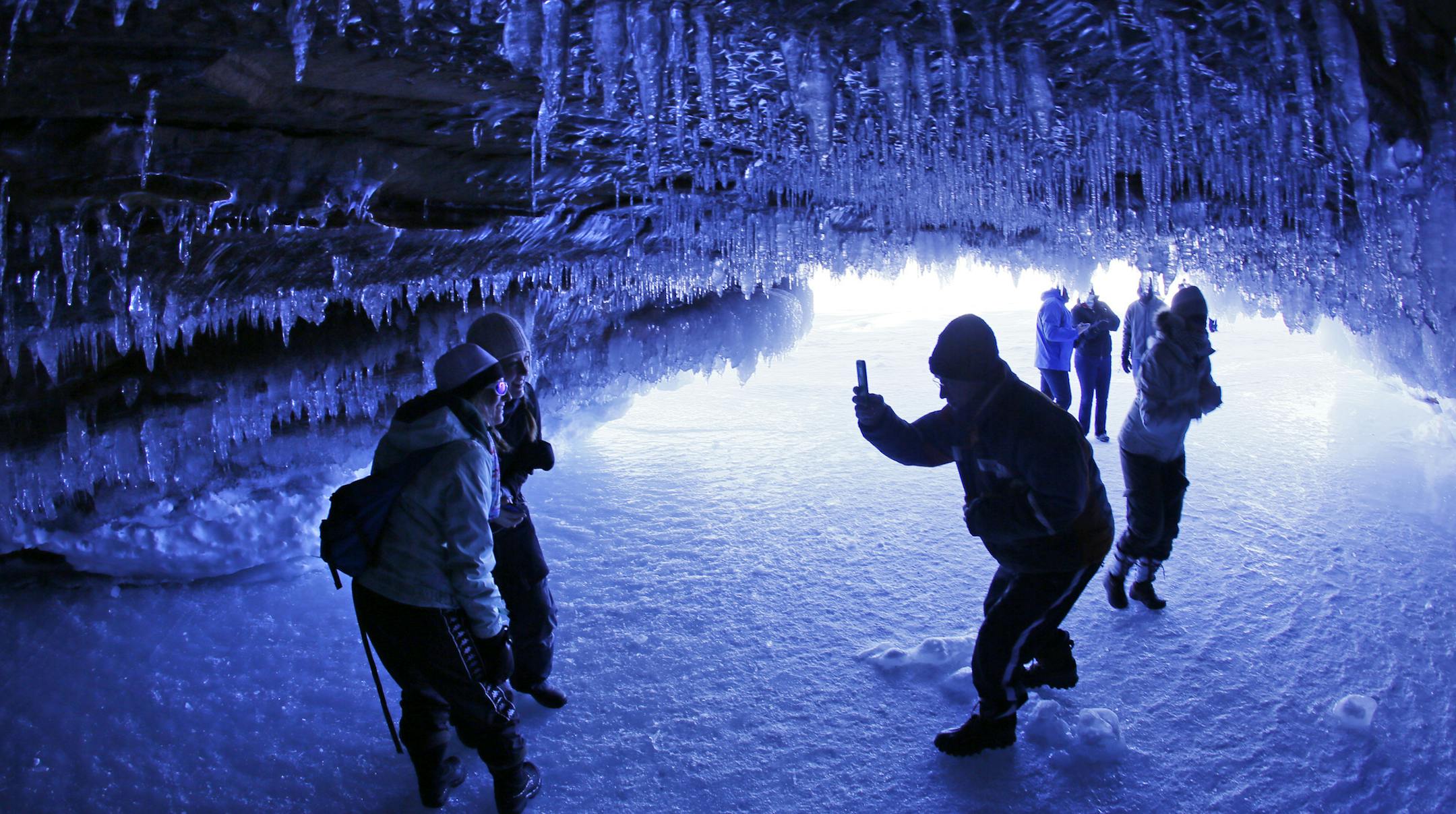 It's been 5 years since the ice has frozen along the south shore of Lake Superior, creating access to the wonders of the Ice Caves of the Apostle Islands National Lakeshore. Over the weekend over 8,000 people made the pilgrimage, a mile walk along the frozen shore, to witness and photograph the crystal wonders of the caves. ] BRIAN PETERSON &#xef; brianp@startribune.com Cornucopia, WI 02/02/2014 ORG XMIT: MIN1402030841040619