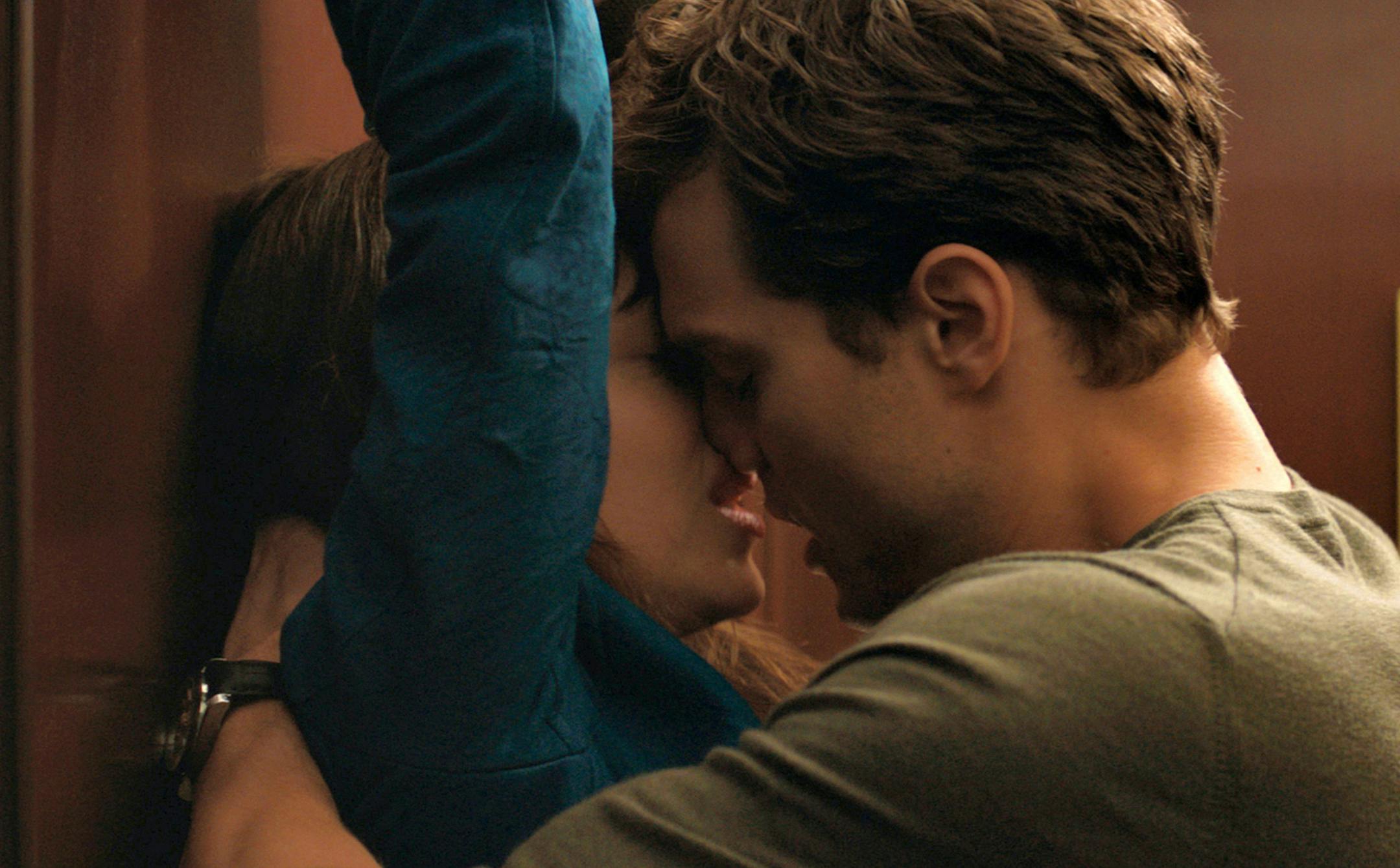In this image released by Universal Pictures and Focus Features, Dakota Johnson, left, and Jamie Dornan appear in a scene from "Fifty Shades of Grey."