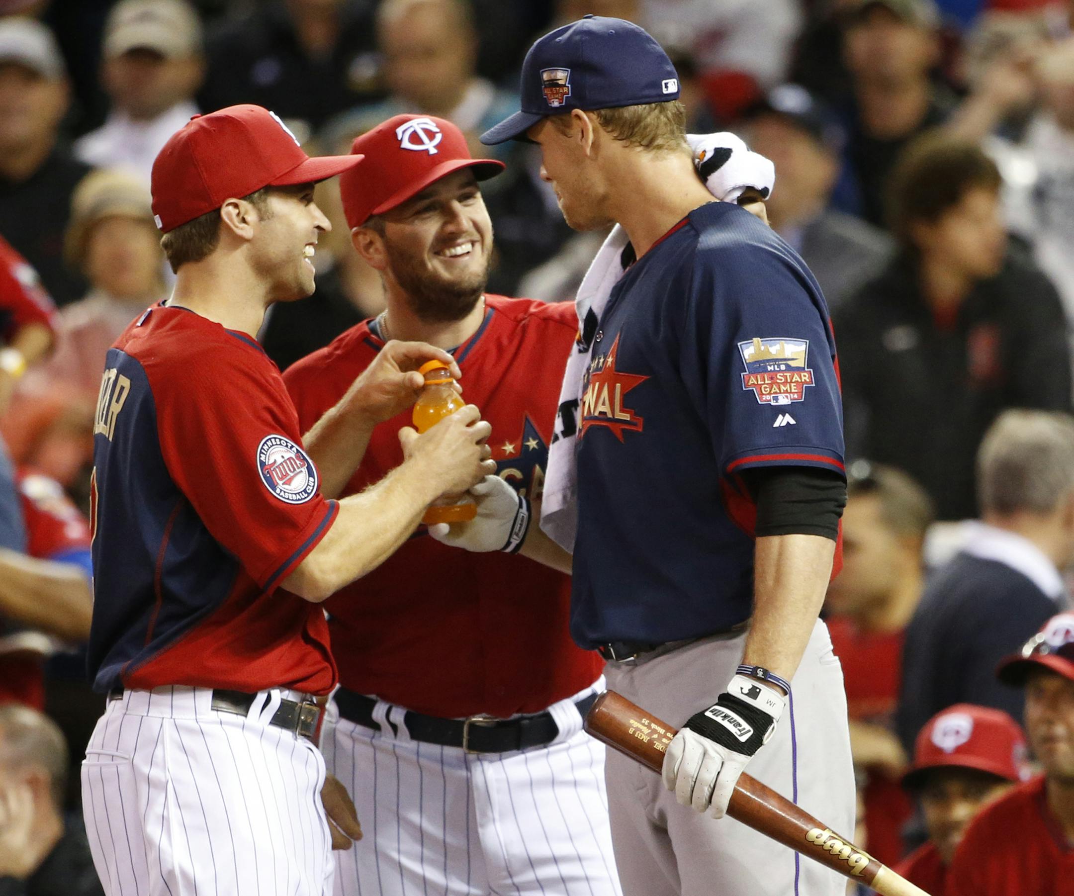 Former twin National League, Justin Morneau, COL gets a little tlc fro the twins player during the All-Star Home Run Derby ] CARLOS GONZALEZ cgonzalez@startribune.com - July 14, 2014 , Minneapolis, Minn., Target Field, All Star Home Run Derby