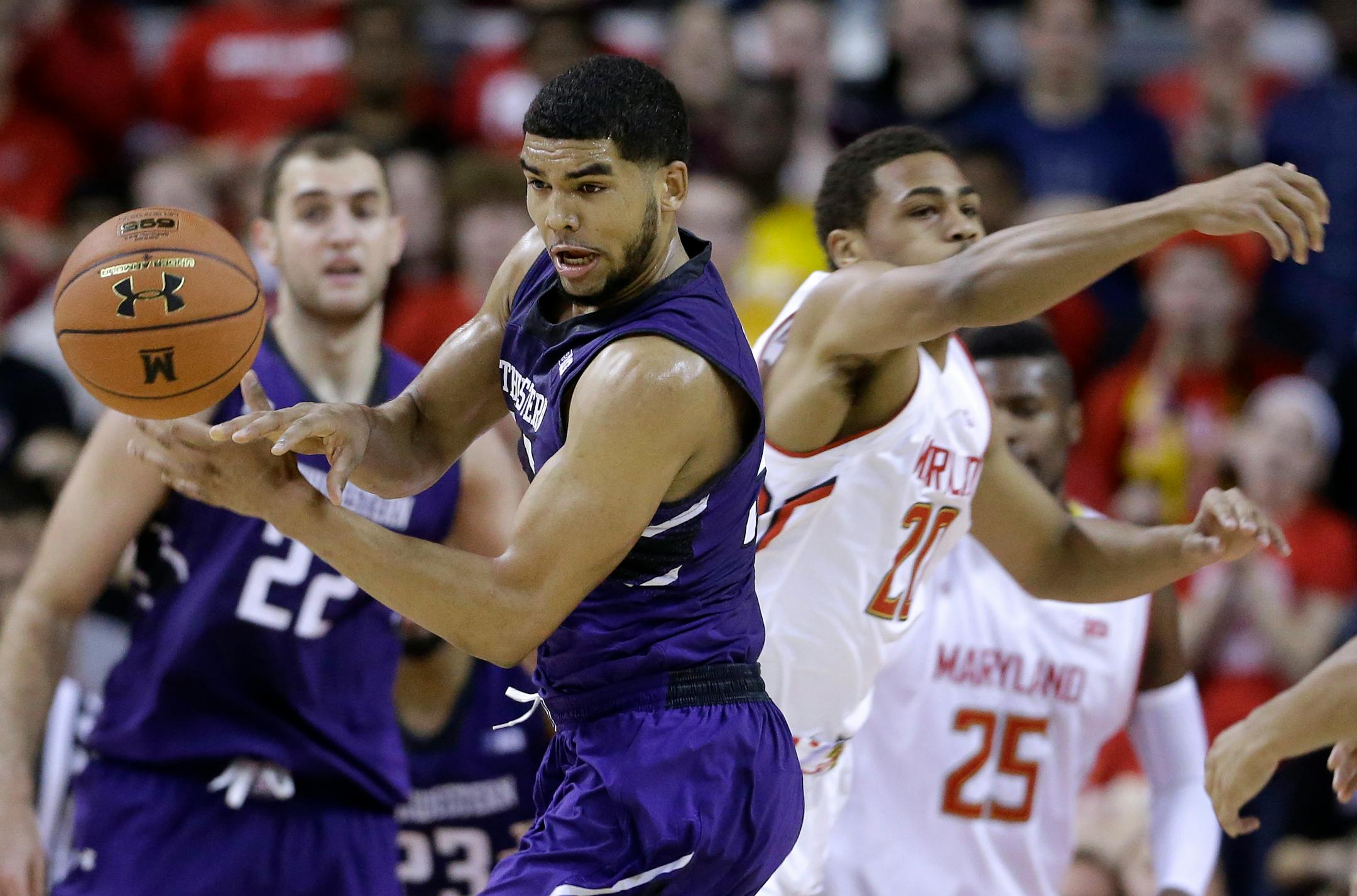 Northwestern guard/forward Sanjay Lumpkin, left, tries to keep control of the ball in front of Maryland guard Richaud Pack in the second half of an NCAA college basketball game, Sunday, Jan. 25, 2015, in College Park, Md. (AP Photo/Patrick Semansky)