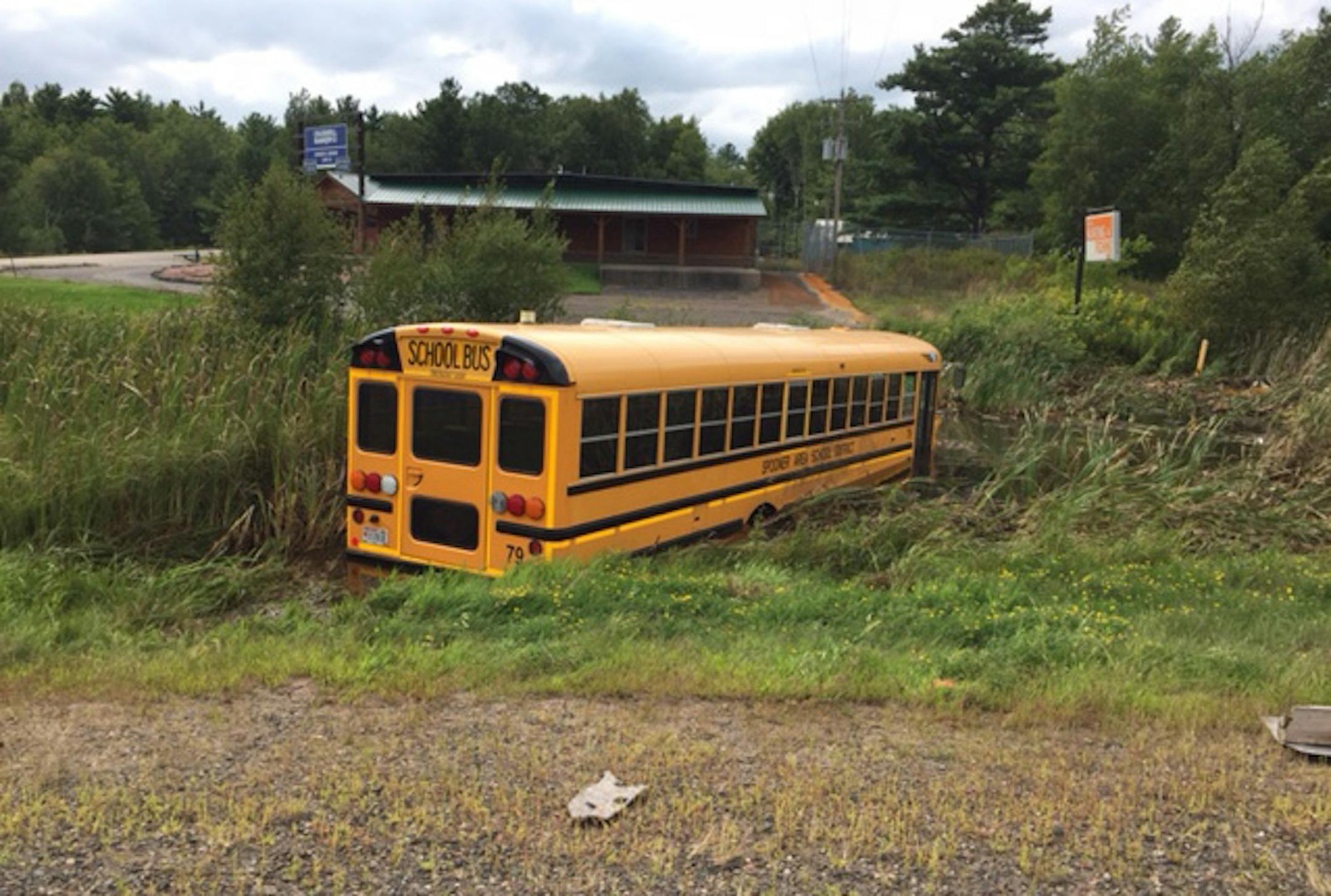 The Spooner High School volleyball teamís bus ended up in a ditch after a crash Saturday killed two people in a car. Credit: Wisconsin State Patrol
