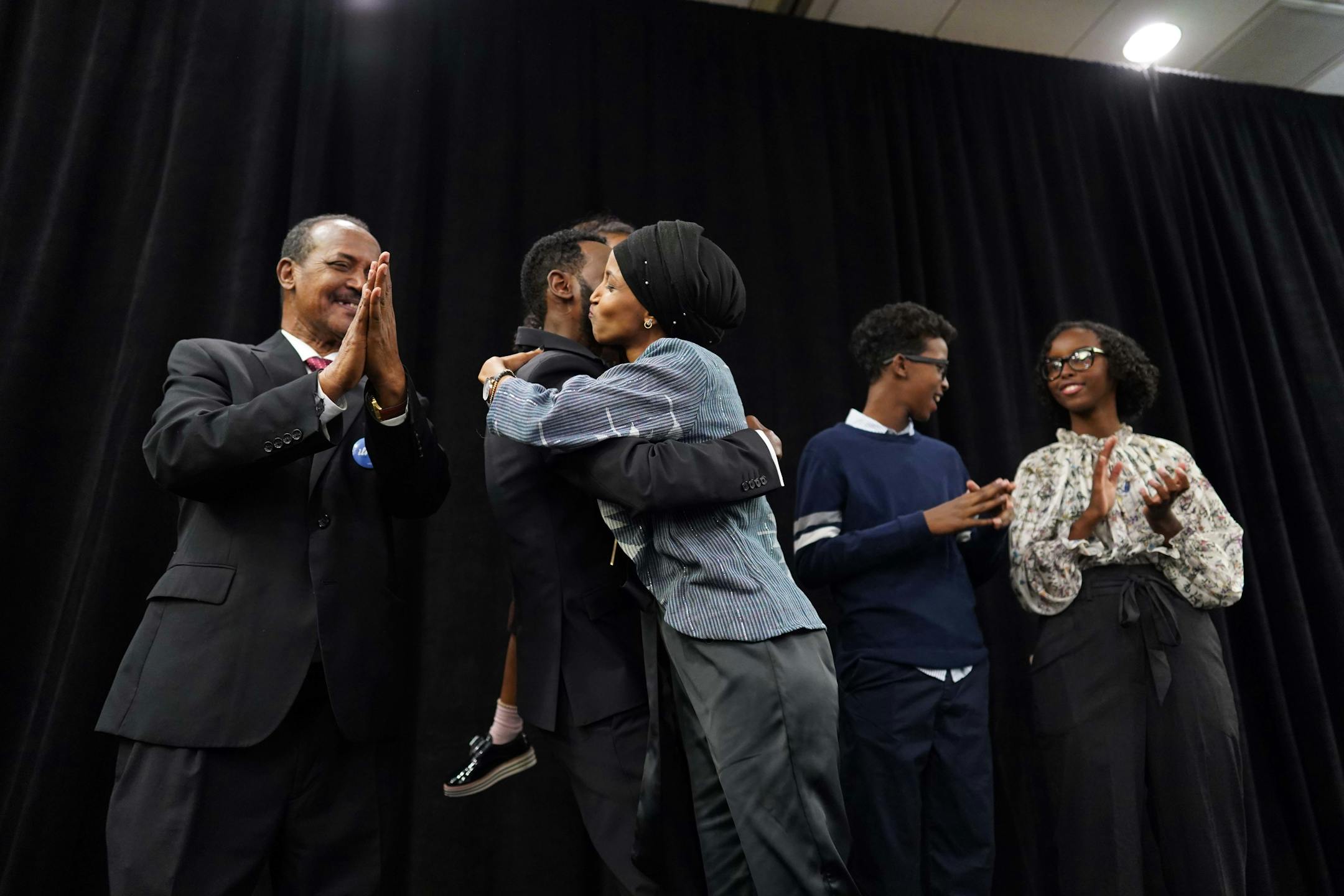 Ilhan Omar embraces her family on stage. ] MARK VANCLEAVE • mark.vancleave@startribune.com * Ilhan Omar is poised to become the first Somali-American elected to Congress, representing Minnesota's Fifth District. Photographed at her election night headquarters in Minneapolis on Tuesday, Nov. 6, 2018.