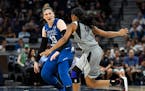 Minnesota Lynx guard Lindsay Whalen (13) directed her teammates while moving the ball down the court under defense by Las Vegas Aces guard Moriah Jeff