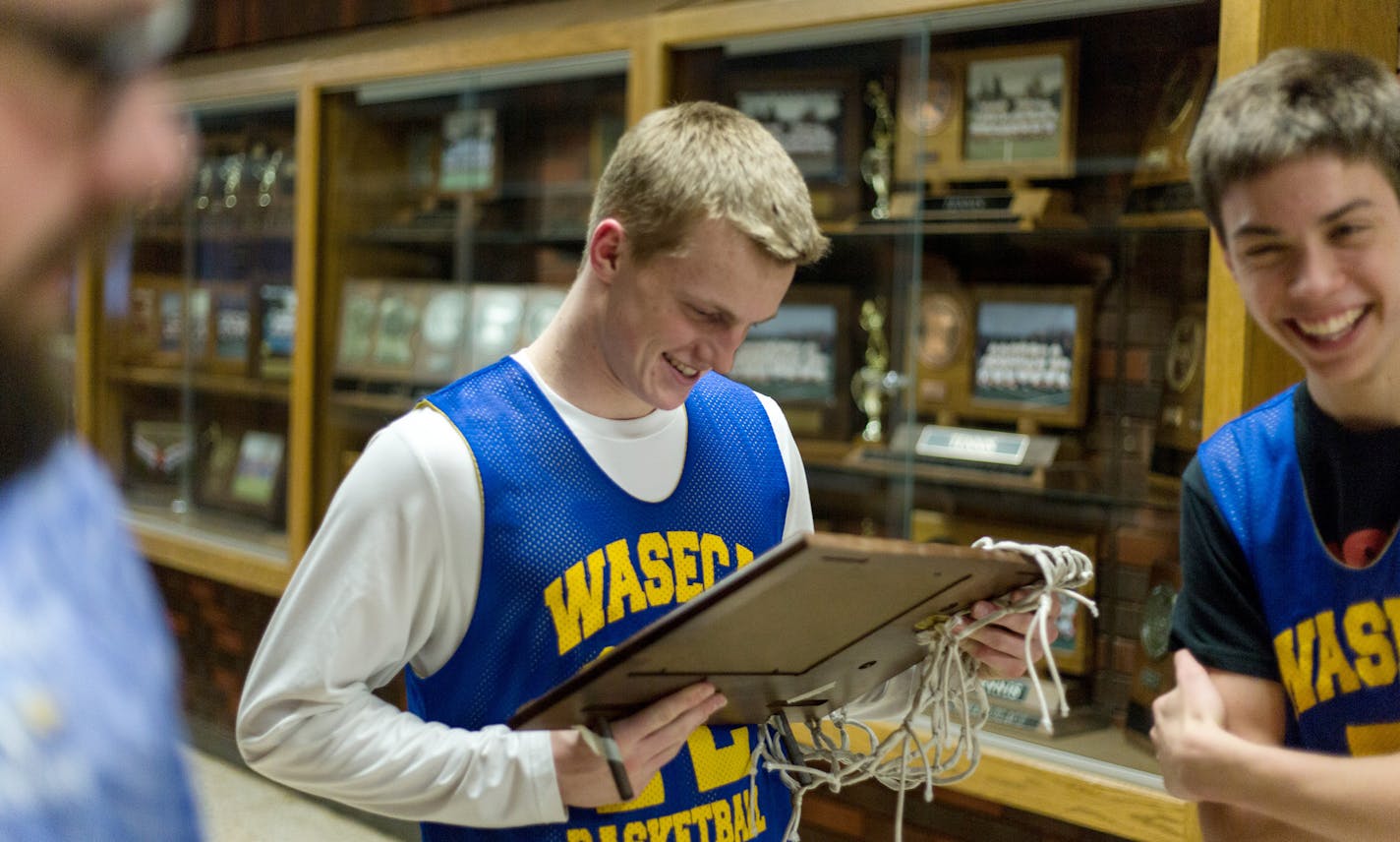 Senior Nick Dufault, with the same hands that sank an 80-foot basket, held Waseca High School's section title trophy.