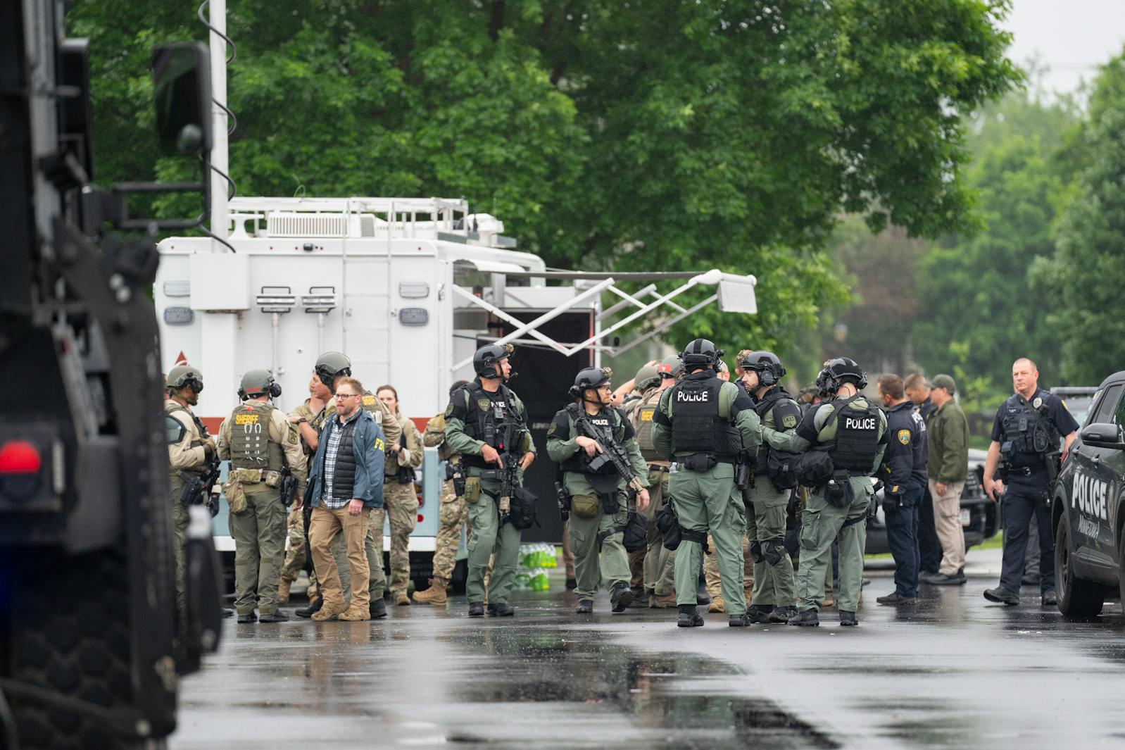 At least one hundred law enforcement officers including local police, sheriffs and the FBI, stage less than a mile from the home of Minnesota DFL State Representative Melissa Hortman in Brooklyn Park on Saturday. 