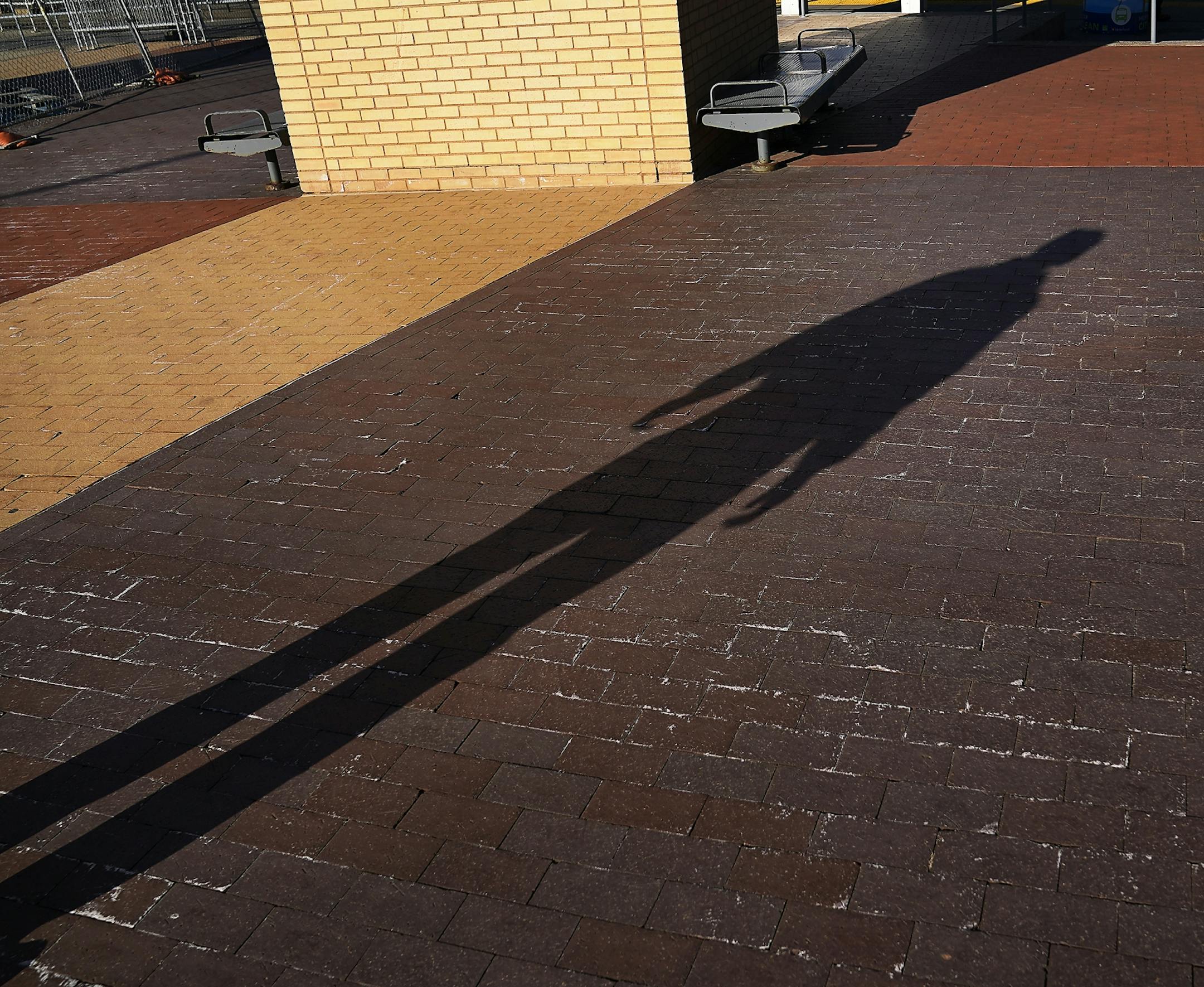 Allen Touche, 48, cast a shadow near benches he once slept on near the US Bank Stadium light rail station during his weekly Saturday journey from his current residence in South St. Paul to Minneapolis to help feed homeless Natives and others in Minneapolis.
