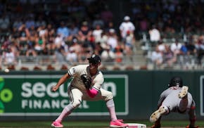The Twins' Brooks Lee bends to catch a throw before tagging out the Giants' Heliot Ramos, who was trying to steal second Sunday. Lee was playing short