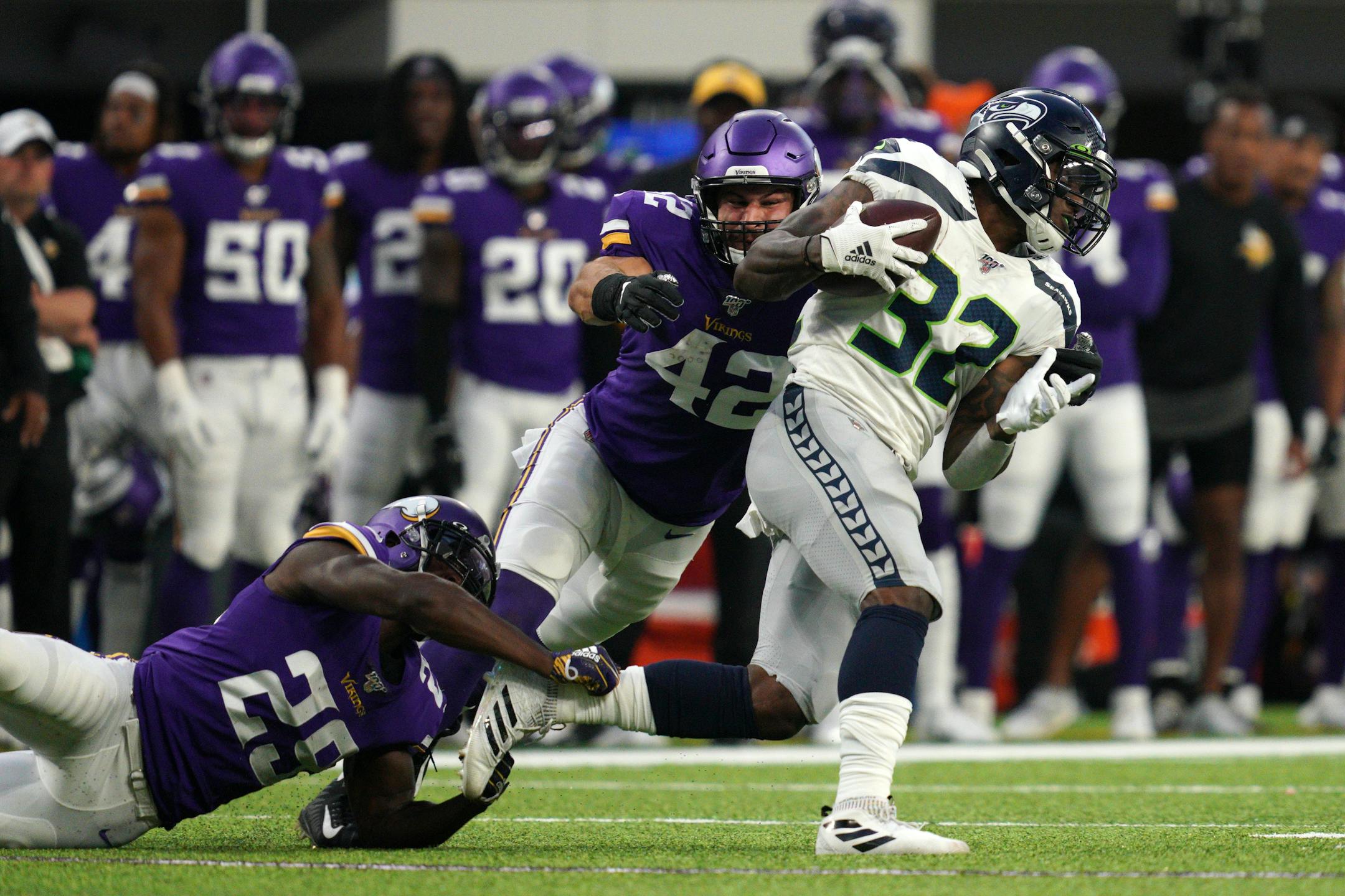 Vikings cornerback Xavier Rhodes (29) and outside linebacker Ben Gedeon brought down Seahawks running back Chris Carson in the first half Sunday.