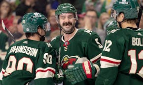 Jake Middleton (5) of the Minnesota Wild celebrates with teammates after scoring in the first period.