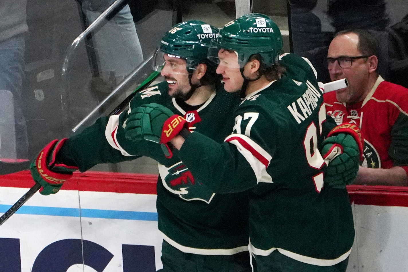 Minnesota Wild's Kirill Kaprizov (97) and Mats Zuccarello celebrate a goal by Kaprizov against the Carolina Hurricanes in the third period of an NHL hockey game, Saturday, Feb. 12, 2022, in St. Paul, Minn. (AP Photo/Jim Mone)