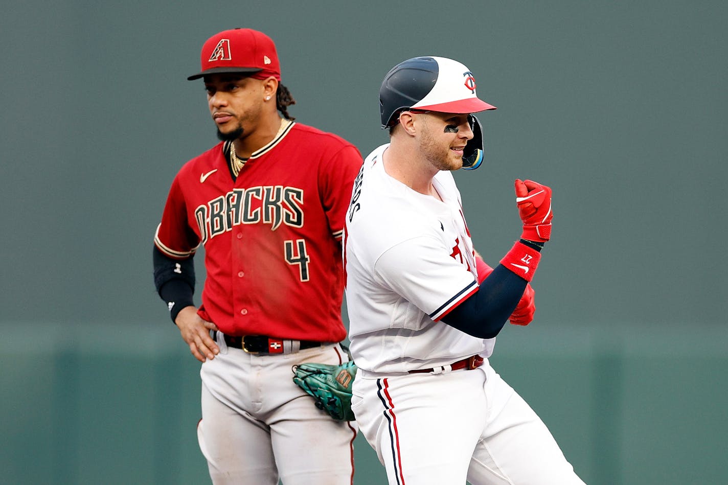 The Minnesota Twins' Ryan Jeffers, right, celebrates his RBI double as Arizona Diamondbacks infielder Ketel Marte looks on in the third inning at Target Field on Saturday, Aug. 5, 2023, in Minneapolis. (David Berding/Getty Images/TNS) ORG XMIT: 86604689W