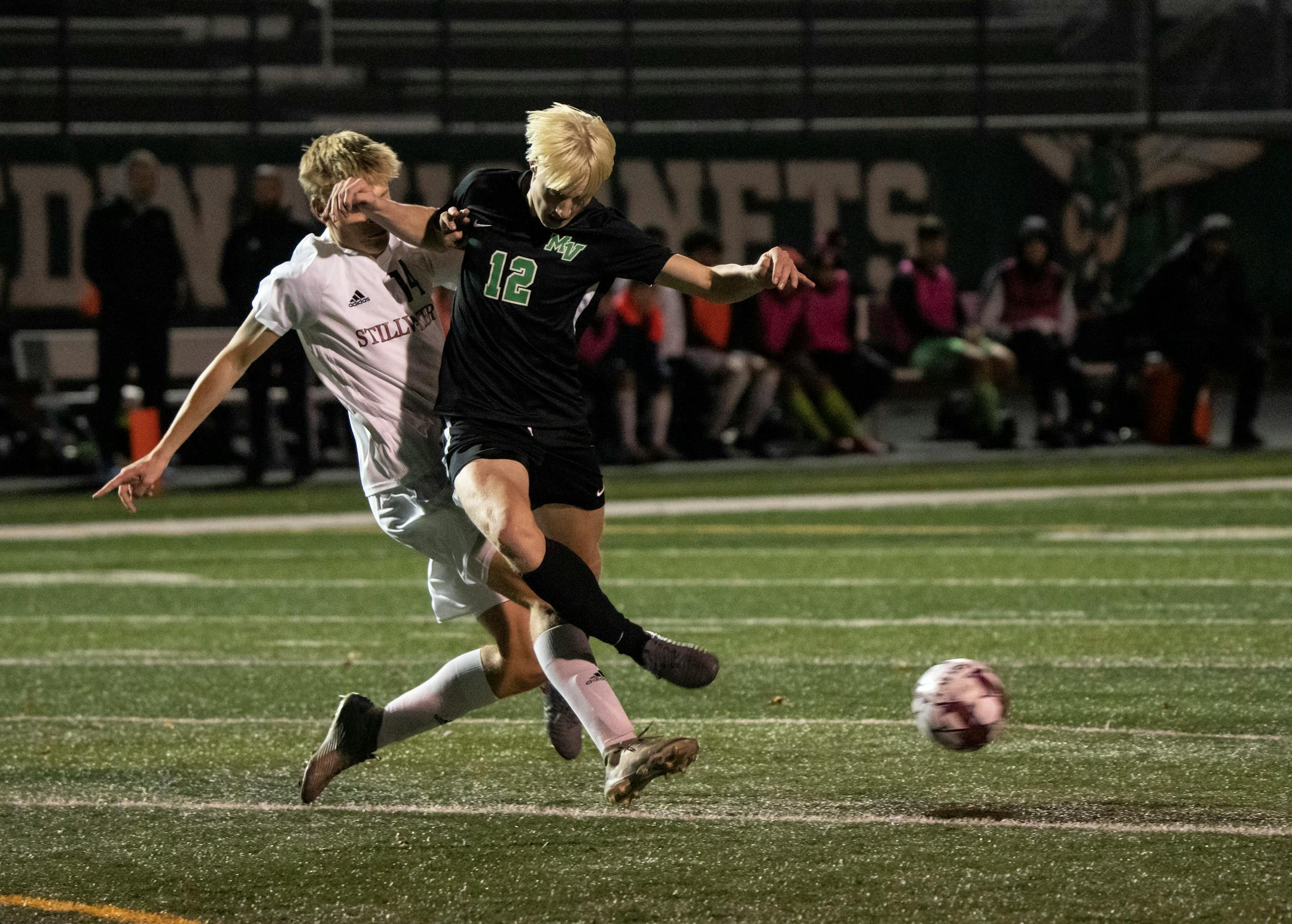 Stillwater Area Jacob Ralston (14) collides midair with Mounds View forward Sam Hoyt (12) as Hoyt kicks the ball in the second half. Mounds View played Stillwater Area in the boys Class AAA quarterfinals in Edina, Minn., Tuesday, Oct. 26, 2021. ] RENEE JONES SCHNEIDER • renee.jones@startribune.com