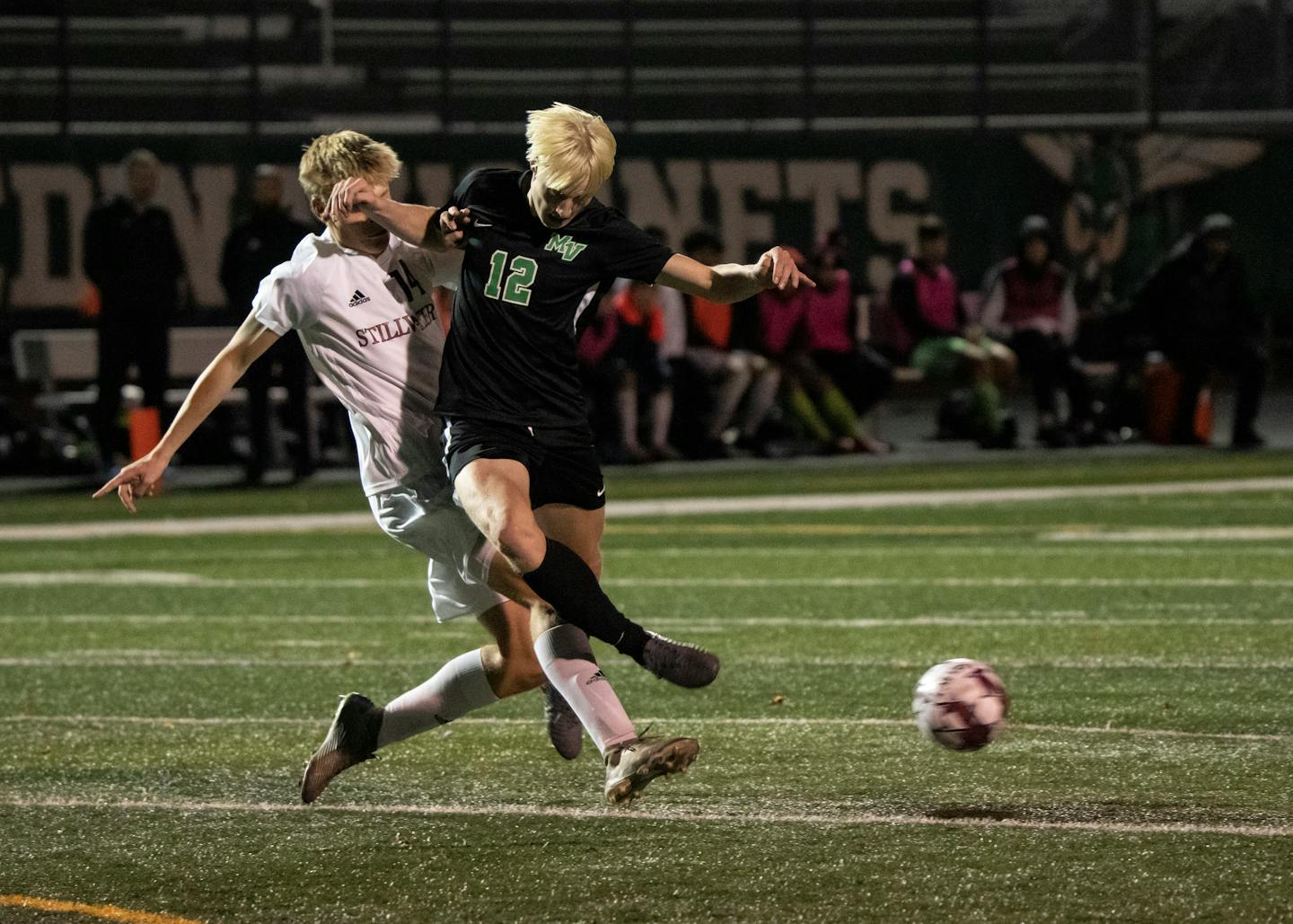 Stillwater Area Jacob Ralston (14) collides midair with Mounds View forward Sam Hoyt (12) as Hoyt kicks the ball in the second half. Mounds View played Stillwater Area in the boys Class AAA quarterfinals in Edina, Minn., Tuesday, Oct. 26, 2021. ] RENEE JONES SCHNEIDER • renee.jones@startribune.com