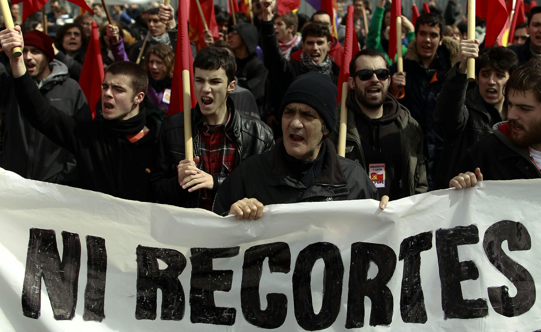 Demonstrators shout slogans as they carry a banner reading, "No financial cuts" during a protest against unemployment and austerity measures in Madrid, Spain, Sunday, March 10, 2013. Tens of thousands of demonstrators march in dozens of Spanish cities to protest sky-high unemployment, what they say is the government's inefficient handling of the economy and corruption scandals, including one engulfing the royal family. Spain's unemployment rate is at a staggering 26 percent and the economy is im