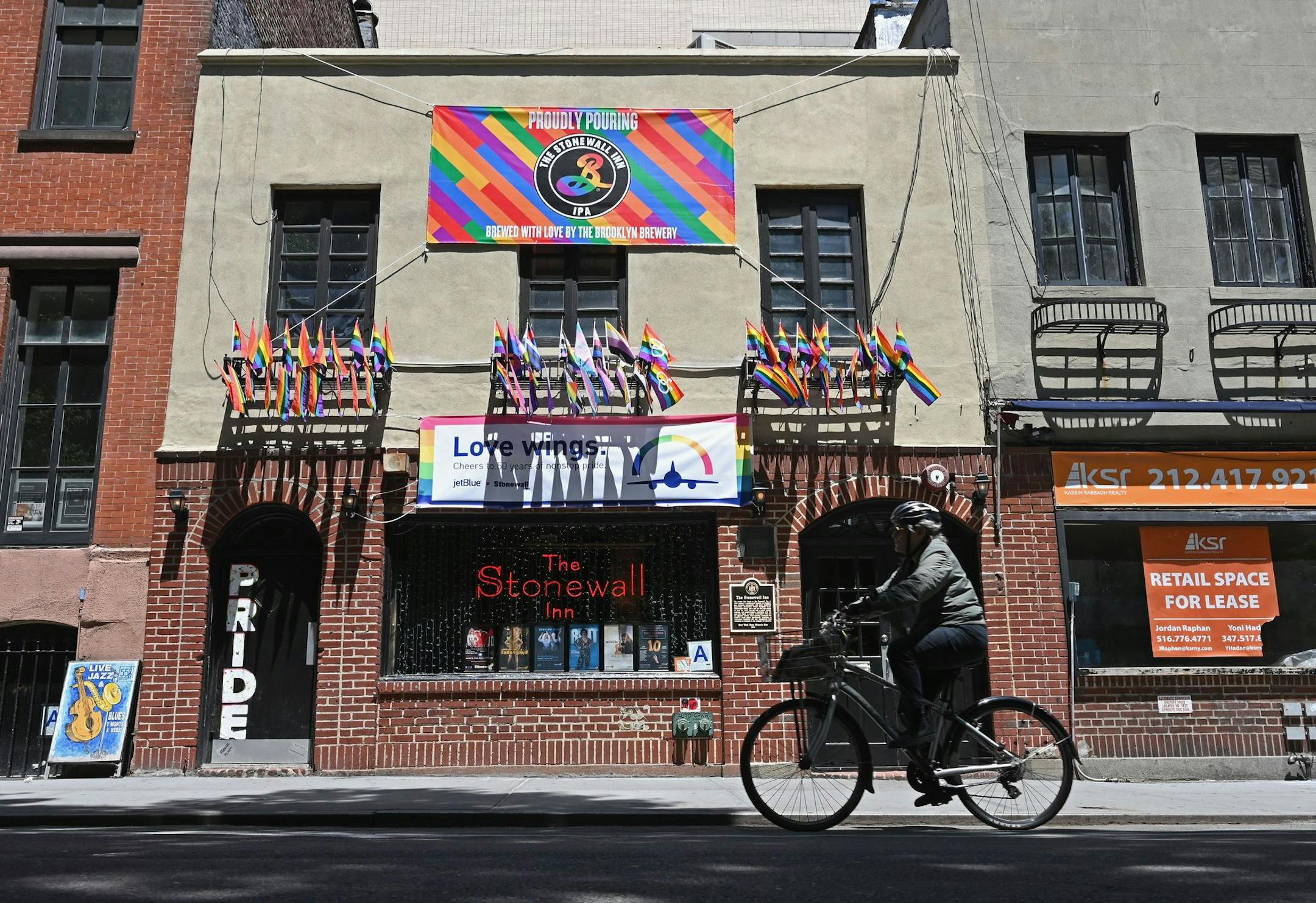 A bicyclist rides past the Stonewall Inn in New York City. Riots at the bar in 1969 helped launch the gay rights movement.