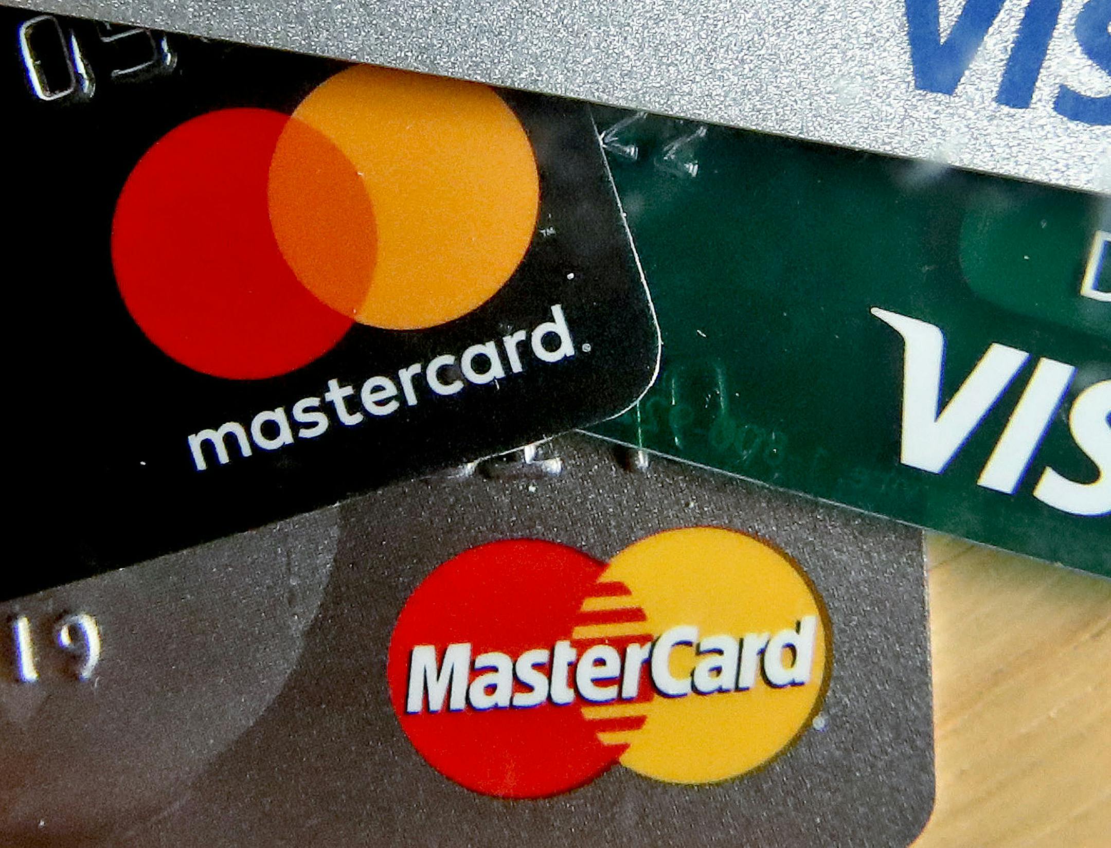 FILE - In this Feb. 20, 2019, file photo photo shows a logo for Mastercard on credit cards in Zelienople, Pa. Mastercard will allow transgender people to use their chosen names on credit cards in an effort to combat potential discrimination at the cash register. That means that the name on the credit card owned by a transgender person could be different than that found on their birth certificate or driver&#x2019;s license. (AP Photo/Keith Srakocic, File)