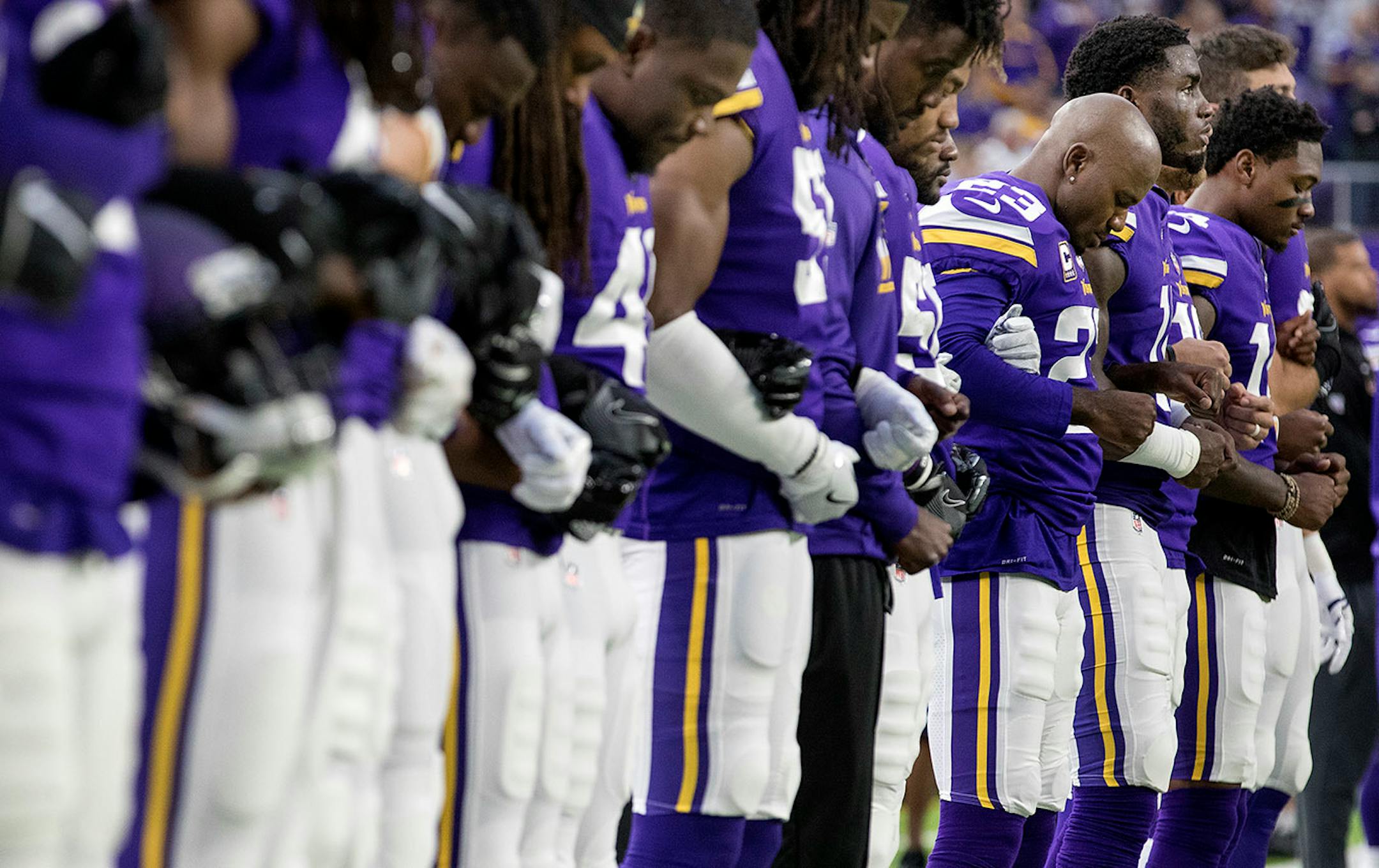 Minnesota Vikings players joined arms during the National Anthem before the start of the game.