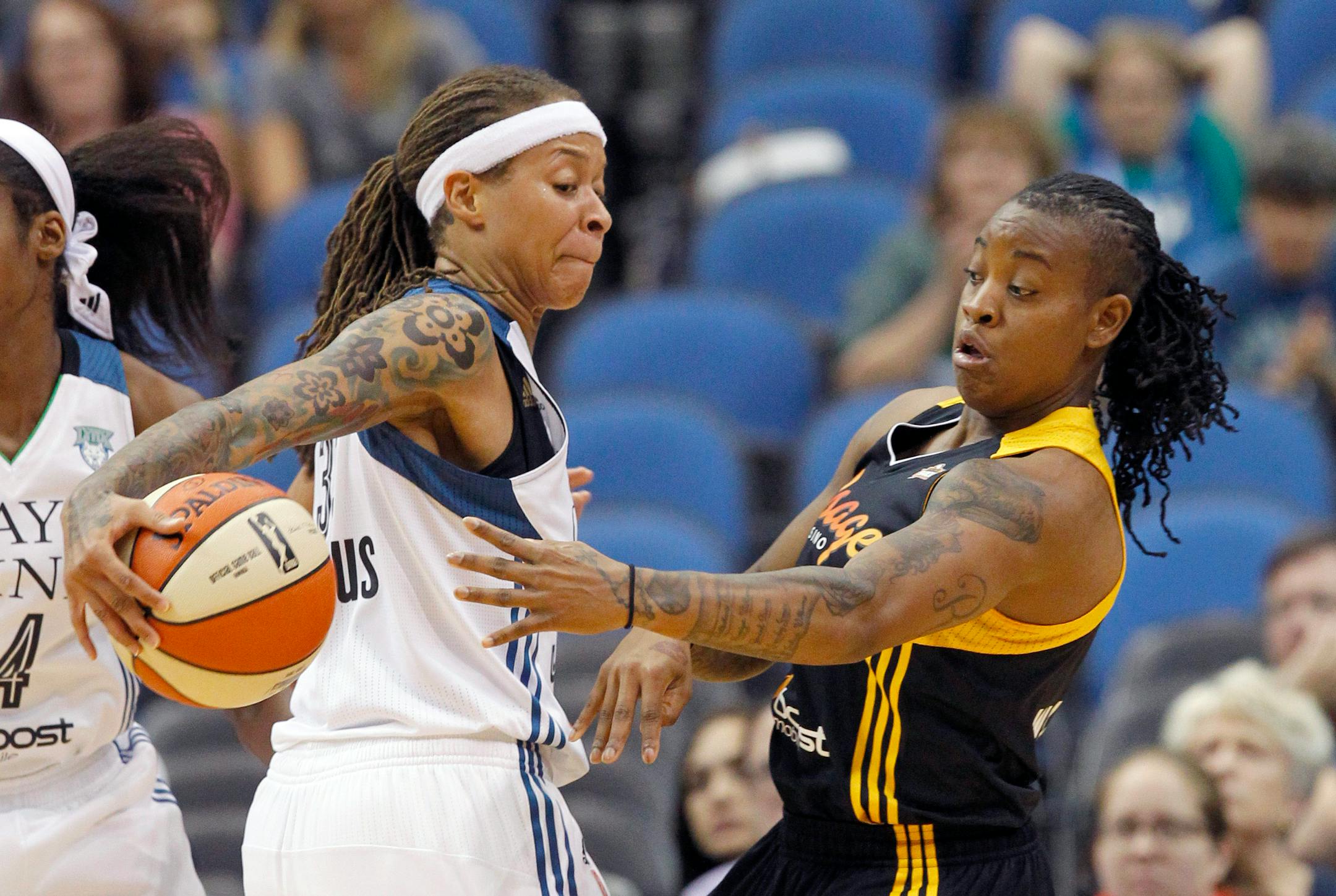 Minnesota Lynx guard Seimone Augustus, left, steals the ball from Tulsa Shock guard Riquna Williams, right, during the first half of a WNBA basketball game in Minneapolis, Friday, June 5, 2015. (AP Photo/Ann Heisenfelt)