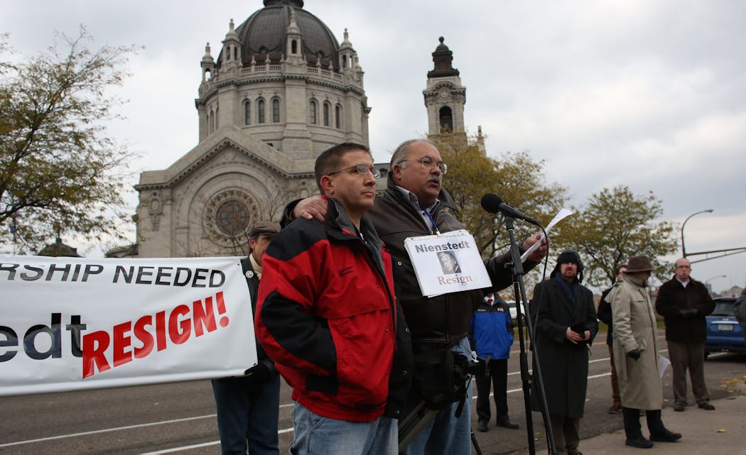 Bob Schwiderski of Minnesota SNAP, right, with Shawn Plocher addressed more than 100 protesters as they asked for the resignation of Archbishop John Nienstedt across the street from the Cathedral of St. Paul on Nov. 9, 2013. Plocher was a victim of abuse in the 1980s.